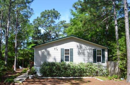 Well maintained mobile home on a quiet paved road in Santa Rosa Beach. This home offers a spacious master bedroom and one additional bedroom. The additional bedroom can be easily transformed into an office. Covered porch allows plenty of space to entertain your guests while enjoying the a view of the woods. Beautiful garden like yard and green plush yard.