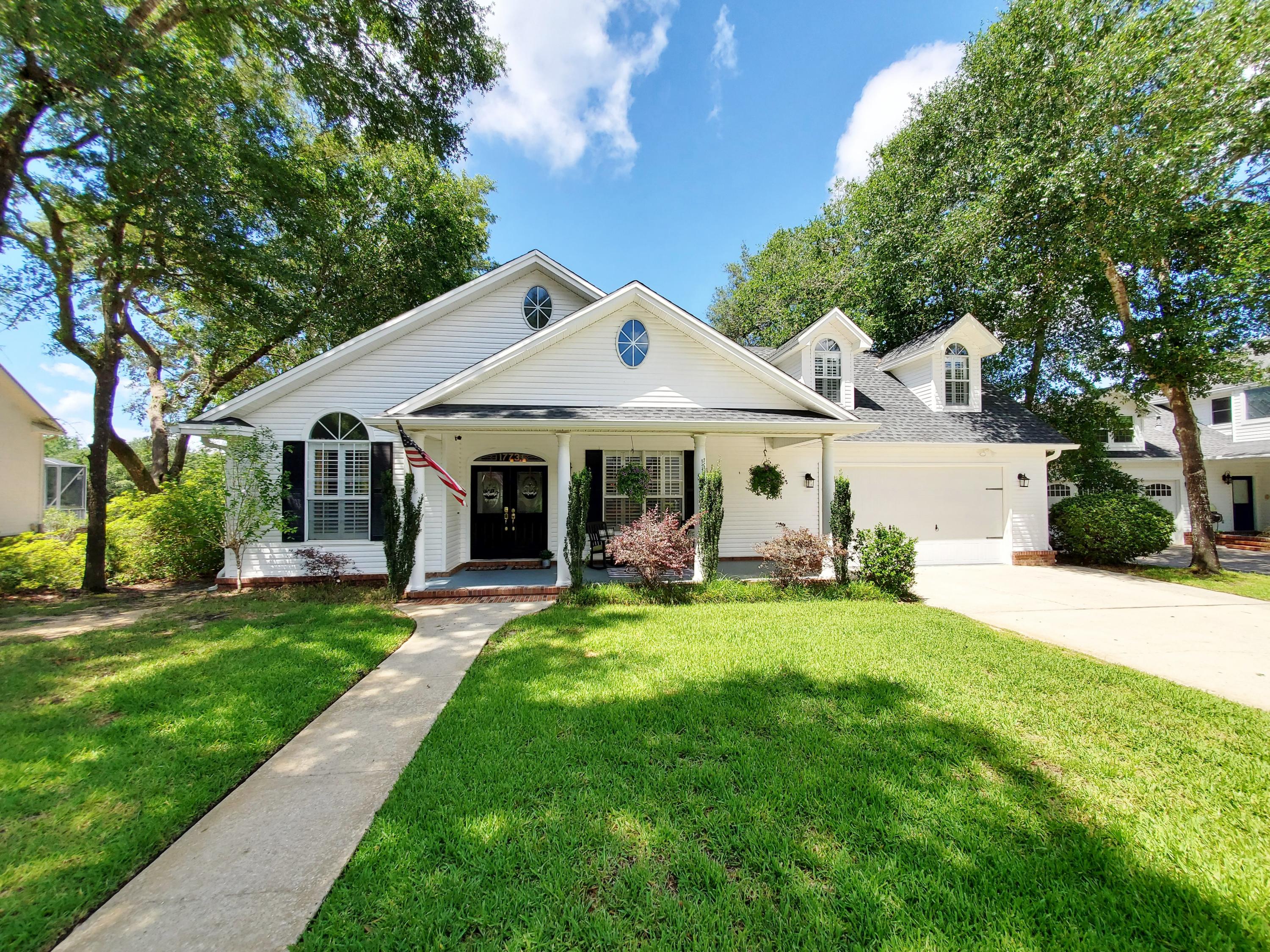 PRICE REDUCED & READY FOR AN OFFER! Welcome home to this beautiful lakefront, well-designed 4 bedroom/ 3.5 bath + bonus room home in the much sought after community Village Of Bolton within the gates of Parkwood Estates. A home like this Randy Wise Builder home on a premium lakefront lot location with oak canopied streets does not come on the market often. Upon entering the front entrance from the covered front porch, you are drawn to the soaring ceilings with ample natural light filtering through plantation shuttered windows. The great room offers bamboo wood flooring, gas fireplace, art alcoves and the beginning of this open and flowing floorplan with views of the back deck overlooking the beautiful estuary beaver lake. Just off the foyer to the left is a guest room/ office with large walk-in closet, custom windows and to the right is the formal dining room with trayed ceiling. The kitchen which is designed for entertaining has been recently upgraded with granite countertops and backsplash along with a hammered copper farm sink, gas cooktop, custom hood vent and this chef's dream kitchen is also appointed with a coffee pantry station and an additional built-in buffet/ kitchen office off of the café area. The master bedroom also offers lake views along with vaulted ceiling, a large walk in closet in addition to another closet off the master bath. The master bath is appointed with a jetted tub, separate shower and separate vanities. The third bedroom on the first floor also has vaulted ceilings, custom sitting window still, private bath and an extra nursery/ workout room. French doors off of the kitchen cafe area lead you to a window lined florida room overlooking the lake and onto an expansive bench lined deck perfect for cookouts, seafood boils, entertaining and enjoying vistas of the backyard, dock and estuary lake. The second floor is the 4th bedroom, loft, and bonus room level. The 4th bedroom is also equipped with a private bathroom. There is also a loft area that leads to another private bonus room. While you are up there check out the walk in attic access areas already equipped with flooring, natural lighting from attic windows and plenty of space and headroom for extra storage. The 2 car garage has not been overlooked as well with a newly epoxy covered floor, built in cabinetry/ workbench and slatted wall for storing equipment. This gated community has private access to Bluewater Bay Elementary without leaving the front gate. Lake front location within a gated community and so many extra custom features makes this home a not miss on your list.