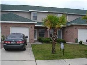 Well maintained townhome right in the heart of Destin in the Magnolia Park neighborhood. The downstairs has hardwood floors in the family room and dining area. Tile in the kitchen and bathrooms. Half bath and laundry downstairs. The glass sliding doors open to a private patio and fenced back yard. Carpeted bedrooms upstairs are good size and each has their own bathroom and walk-in closet. This home also has a 1 car garage