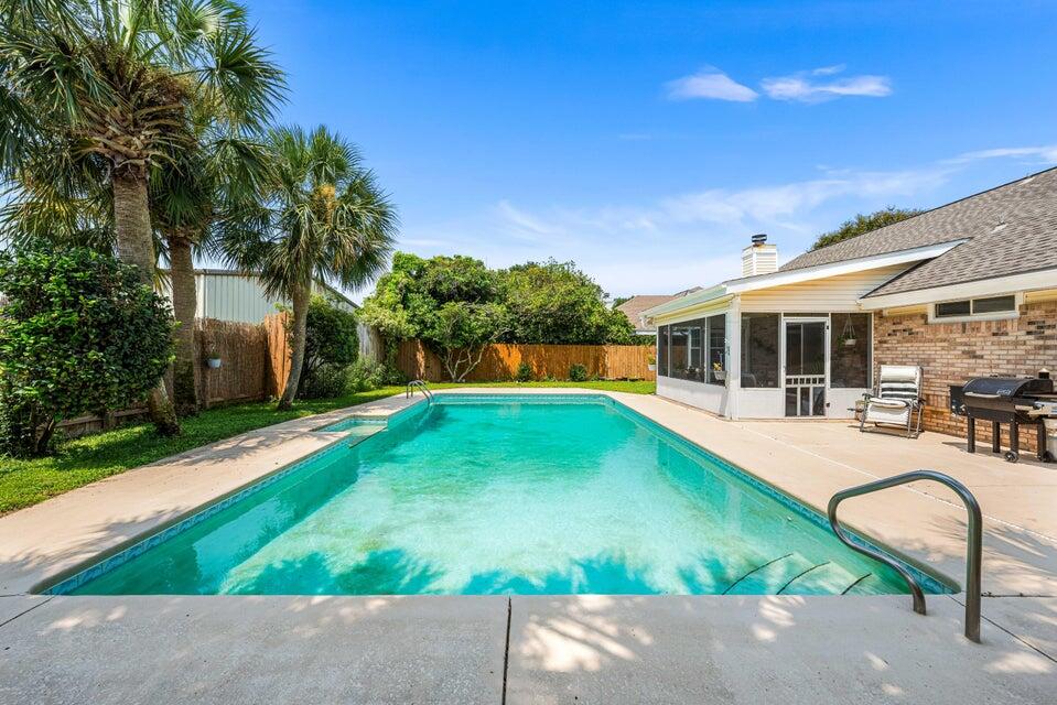 Welcome to your dream home in the heart of Destin! This stunning and spacious four-bedroom, three-bathroom residence combines comfort with timeless charm, offering everything you need for relaxed coastal living. As you step inside, you'll be welcomed by rich, real hardwood floors that flow throughout the main living and dining areas. The living room features soaring vaulted ceilings and a cozy fireplace, creating a warm and inviting space for gathering with family and friends. Just off the living room, the newly added sunroom offers a serene spot to enjoy your morning coffee or unwind after a long day.

The first-floor primary suite is a peaceful retreat, complete with an en suite bathroom and two generously sized closets. A second guest bedroom is also conveniently located downstairs, along with a beautifully renovated full bathroom. The kitchen is a delight for any home chef, featuring granite countertops, stainless steel appliances, and an eat-in dining area that's perfect for casual meals. A versatile flex room on the main level can be used as an office, playroom, home gym, or whatever suits your lifestyle.

Upstairs, you'll find two additional bedrooms and a shared bathroom, along with a cozy loft space ideal for a reading nook or extra lounge area. Outside, the fully fenced backyard is your private oasis, complete with a large in-ground pool that's perfect for entertaining or simply enjoying the Florida sunshine. The home also includes a two-car garage with additional parking space for three more vehicles in the driveway.

Located in the heart of Destin, this home puts you close to local dining, shopping, the Destin Harbor, and the area's iconic white sandy beaches. Pets may be considered with owner approval and a non-refundable pet fee. Smoking and vaping are not permitted.

Don't miss the chance to make this exceptional home your next rental - schedule your tour today!
