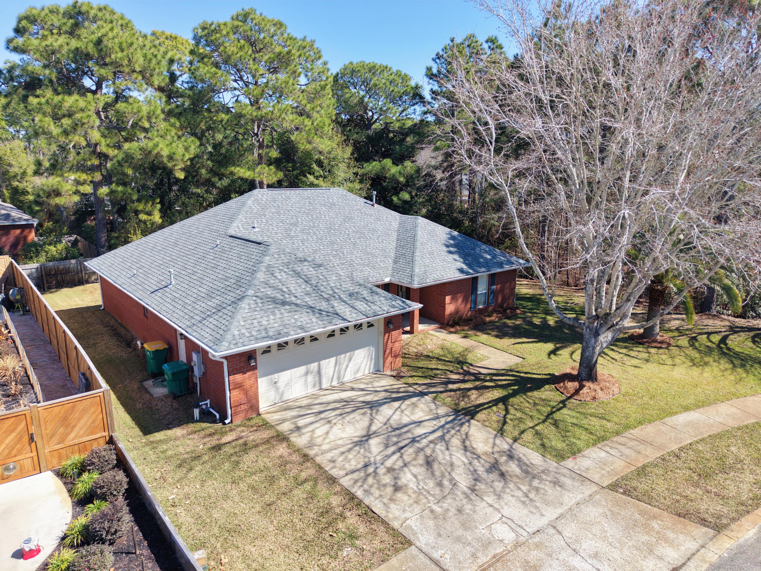 Move in ready! 2.25% VA assumable! Secluded on the north side of Destin in a quiet neighborhood, this beautiful 4-bedroom / 3-bathroom home is perfect for a growing family. You are met with a large foyer walking in the front door and immediately to the left you have a formal dining room or use as an office. The large family room is perfect for movie night or just enjoying the natural gas fireplace with a good book. Off the main living area you have 3 bedrooms and 2 bathrooms. The jack n jill bathroom split the 2 bedrooms and the other bedroom is down the hall with the common bathroom. Behind the living area is the kitchen with an eat in bar and a breakfast nook area. Across from the kitchen is the laundry room that leads out to the 2-car garage... Down the back hall is a large master suite with a bathroom that features a double vanity sink and large shower/tub. Heading out back from the main living area you have a large paver patio perfect for entertaining and hosting cookouts. This lot is surrounding by trees and the lot immediately to the right of the home is wooded lot providing extra privacy. The home has a new HVAC system in 2022, new water heater in 2021, new roof in 2020, and other various updates. A new irrigation system was installed along with new sod in 2025. This home has great character and is ready to be loved by the next family.