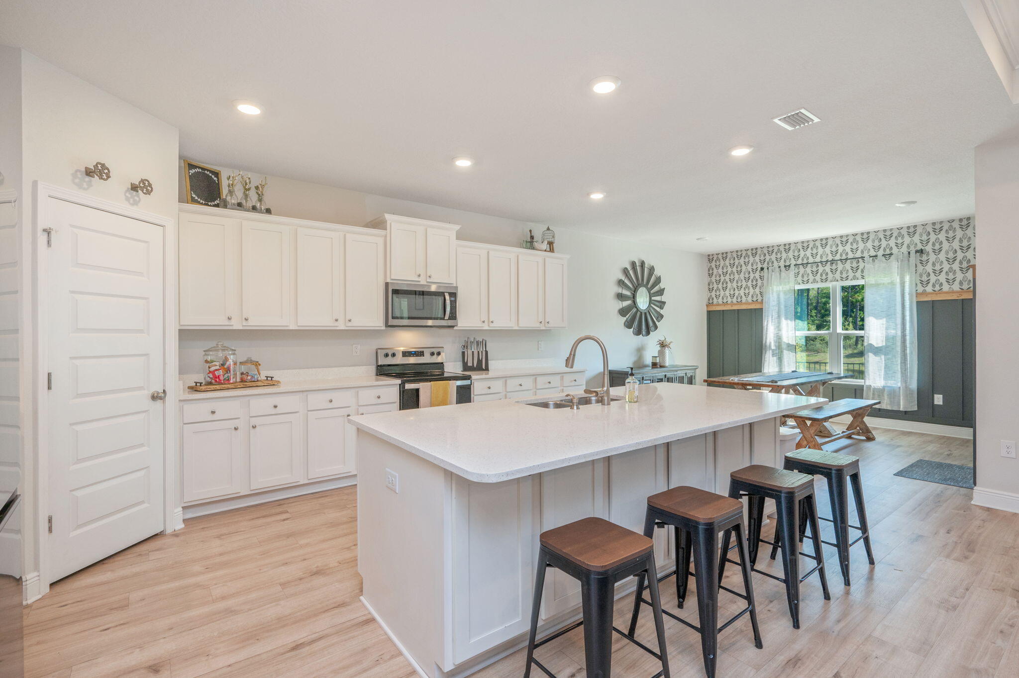 Under contract accepting back-up offers!Just 20 minutes from the white-sand beaches of South Walton and the emerald-green waters of the Gulf, this stunning 2022 Craftsman-style home offers a rare combination of refined design, comfort, and natural beauty. Set on an oversized lot overlooking a peaceful pond and preserved wetlands, the 4-bedroom, 3-bath home invites you to enjoy daily views of native wildlife from your screened-in porch or through the expansive windows of the open-concept living, dining, and kitchen areas. A welcoming foyer enhanced with custom millwork and shiplap sets a warm, coastal tone the moment you step inside.The kitchen is the heart of the home, featuring white cabinetry, quartz countertops, stainless steel appliances, and a spacious island perfect for entertaining The great room is anchored by a custom shiplap feature wall with an upgraded electric fireplace and built-in space for your large-screen TV.
A rare highlight of this home is its two master suitesone with private access to the screened-in porch, dual walk-in closets, double vanities, a soaking tub, and a separate walk-in shower, offering a true spa-like retreat. The second master suite also includes a spacious walk-in closet and private bath. Two additional bedrooms are thoughtfully positioned at the front of the home, ideal for guests or a home office. Additional upgrades throughout the home enhance its one-of-a-kind character, and a 3-car garage offers ample storage. Located just a half-mile from Hammock Bay, you're within walking distance of weekend markets, live music, restaurants, and community events. This home is the perfect blend of peaceful natural surroundings and vibrant neighborhood living.