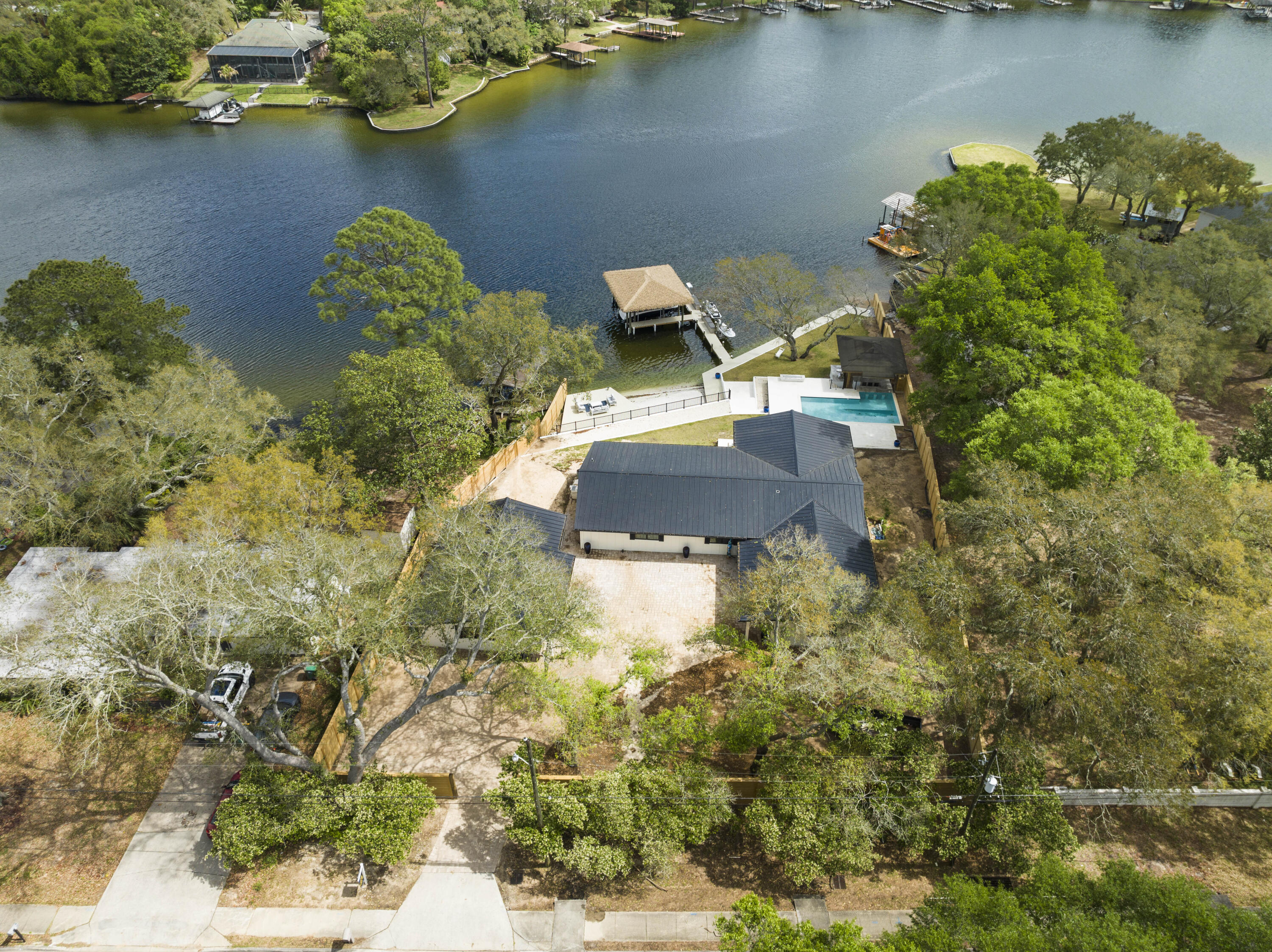 Waterfront home in the Kenwood Subdivision, sits on over 1/2 acre, with 150' of  waterfront footage.  Extensive exterior renovations have been made (see the full list in the documents section), the interior has been gutted and is framed and ready to go.. The seller does also have a set of Plans with engineering for 5 bedrooms/4.5 baths.  New impact windows, sliders and front door with 3 retracting 12' sliders in great room have been installed.  Fabulous bayou views