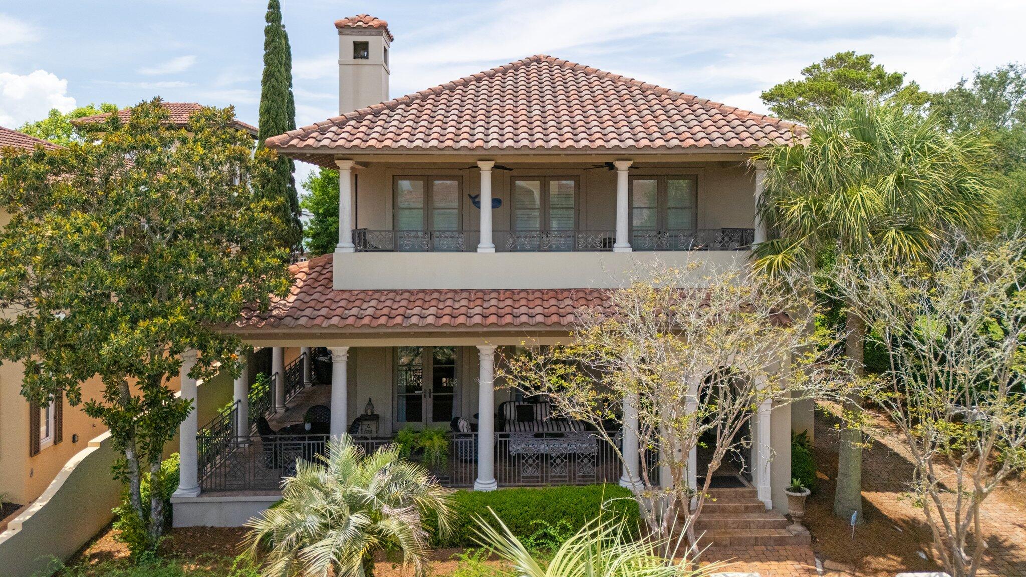 This stunning, fully furnished four-bedroom villa offers plenty of space and sleeping arrangements for up to eight lucky guests eager to enjoy a beach getaway. Nestled in the exclusive gated community of Caribe, it's just a short walk to a private shoreline, while being conveniently near Miramar Beach's vibrant dining, shopping, and entertainment options.
The moment you lay eyes on this two-story home's Mediterranean-inspired facade, you'll know you've found something special. A beautifully landscaped courtyard, adorned with swaying palms, colorful crepe myrtles, and a majestic magnolia, creates a serene tropical ambiance. A spacious covered porch, mirrored by a matching balcony above, beckons you to relax with stylish outdoor furniture, perfect for enjoying meals or drinks in the fresh air.
Step inside this gorgeous home, and you're greeted by warm, inviting interiors that instantly feel like home. Light-toned tile floors sweep through the open-concept living spaces, with high ceilings adding an airy, expansive feel. Elegant arched doorways with decorative accents connect the rooms, leading to a bright dining area where a rustic table, illuminated by a charming chandelier, seats ten comfortably. The adjacent gourmet kitchen boasts granite countertops, a bar with stool seating, creamy cabinetry with crown molding, glass-fronted displays, and top-of-the-line stainless steel appliances. The cozy living room features plush sofas and armchairs in soft blue hues, arranged around a sturdy wooden coffee table, facing a large flat-screen TV above a dormant fireplace. Throughout the home, lively artwork, including tropical paintings and playful beach-themed decor, adds a vibrant touch.
The first-floor master suite is a luxurious retreat, featuring a king-sized bed, an antique-style bench, a pale blue armoire, a comfy armchair with ottoman, and private patio access. Its spa-like en suite bathroom includes dual vanities with granite counters, a deep soaking tub, and a spacious walk-in shower. Upstairs, three tastefully appointed guest bedrooms await. One, resembling a second master suite, has a queen-sized bed, a built-in desk with shelving, balcony access, and a private full bathroom. The other two guest roomsone with a queen bed and another with four twin beds ideal for kids or group staysshare a well-appointed full bathroom.
Caribe's resort-like amenities elevate the experience, with two lushly landscaped pools, restroom facilities, tennis courts, a scenic pier extending into a tranquil lagoon, and easy access to a pristine beach. The villa's prime location puts you minutes from gulf-front eateries, grocery stores, wine shops, and the Silver Sands Premium Outlets, known for designer deals. Nearby championship golf courses, including one at Seascape, are a draw for enthusiasts. Just a short drive away, the charming Village of Baytowne Wharf, inspired by New Orleans' French Quarter, and the upscale Grand Boulevard at Sandestin offer year-round festivals, fireworks, live music, dining, bars, boutiques, and art galleries.
First Floor: Living Room with Patio Access, Kitchen, Dining Area, King Master Suite with Walk-In Shower, Soaking Tub, and Patio Access, Half Bath, Laundry Room.
Second Floor: Queen Bedroom with Full Bath and Balcony Access, Queen Bedroom, Jack-and-Jill Full Bath, Bedroom with Four Twin Beds.