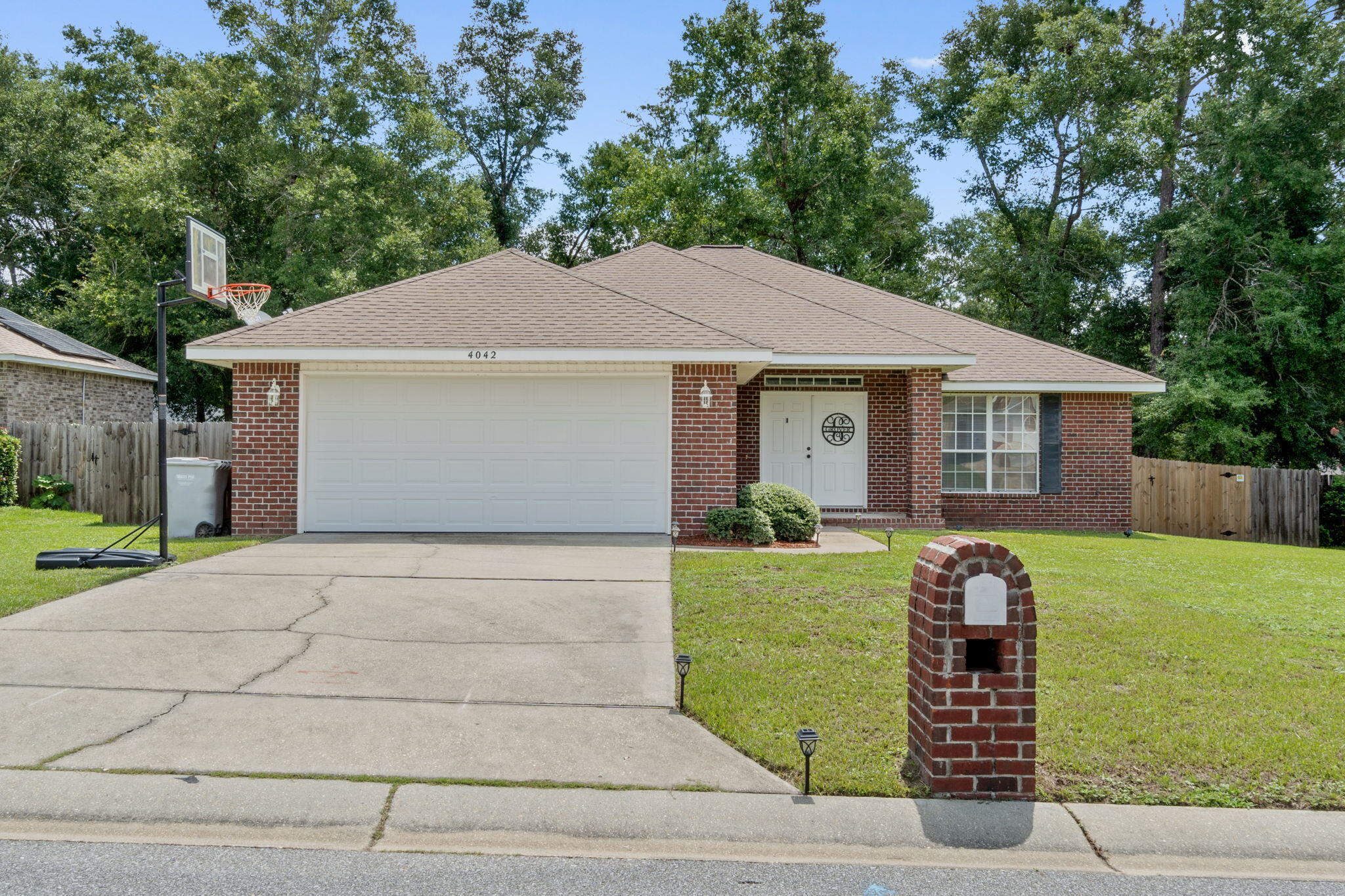 *Brand new water heater and roof will be replaced prior to closing!* Immaculate custom built home tucked away in the great neighborhood (no HOA!) of Woodbury Forest. Excellent location and convenience just off Garcon Point Rd in Milton less than 5 minutes to I-10 or Hwy 90! Easy commute to Whiting Field, Navarre, Pensacola, Crestview, & Ft. Walton Bch. You will love this spacious all brick home boasting over 1950sqft with 3 bedrooms, 2 baths plus a separate forming dining room at the front of the home currently used as a fantastic game room. Freshly painted walls, brand new carpet (that has STILL never been walked on with shoes), and tiled floors in 2020 make this the move in ready home you've been looking for. The layout upon entry through the double front doors opens up into a spacious great room and features trey ceilings to give the room a luxurious feel found in your average home. The great room also opens up into the eat in kitchen and well appointed kitchen where you'll enjoy the open layout. The tiled kitchen features upgraded cabinetry and a new faucet, breakfast bar, large pantry, electric stove, dishwasher, and a refrigerator with ice maker. The master bedroom suite is a fantastic size with another trey ceiling in the bedroom and in the bathroom features double vanities with new faucets, a soaking tub and separate shower, linen closet, and a walk in closet. Then, off the master you have a hallway leading to the other remaining bedrooms, an additional full bathroom, and your own indoor laundry area. Beyond the laundry room, you will find a large 2 car garage that has been upgraded to a smooth popcorn less ceiling. Off the eat in kitchen and through the back door you will find a lovely covered screened porch, which is perfect for soaking in the spacious fully fence back yard complete with a newly added double gate! Welcome home!