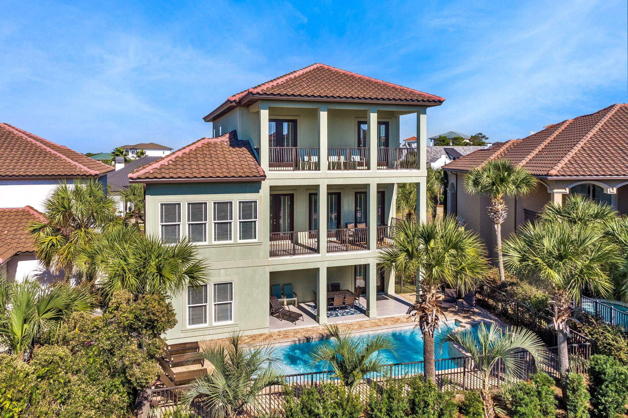 24 Tranquility is one of only five homes in the community with deeded beach access!! Ideally situated in the highly sought after gated community of Destiny East, this five-bed, five-and-a-half-bath retreat built in 2016 is a remarkable beach home that offers gulf views, a private pool with waterfall, and an elevator. Spread over more than 3,700 square feet of living space and, this three-story build features multiple living areas, multiple owner's suites on the first and third floors, and a spacious outdoor oasis for entertaining or relaxing.
Built with a reverse home plan that places the main living and kitchen areas on the second floor, this floor also offers access to a generous balcony with sparkling gulf views. The home's first floor includes easy access to the pool with both covered covered patio and pool deck seating and gas grill, as well as a bunk room and two-car garage. The third floor is occupied by a living area, reading nook and large covered balcony with gulf views. Notable finishes in the home include hardwood flooring throughout, granite countertops and a large kitchen island and pantry. Updated coastal decor and furnishings bring the beach indoors. Destiny East offers some of the best community amenities available on the Emerald Coast, including two neighborhood pools, a hot tub, fitness center, community room, movie theater, tennis and basketball courts, BBQ area, walking trails and playgrounds, all conveniently situated with nearby access to Emerald Coast Parkway and Scenic Highway 98.