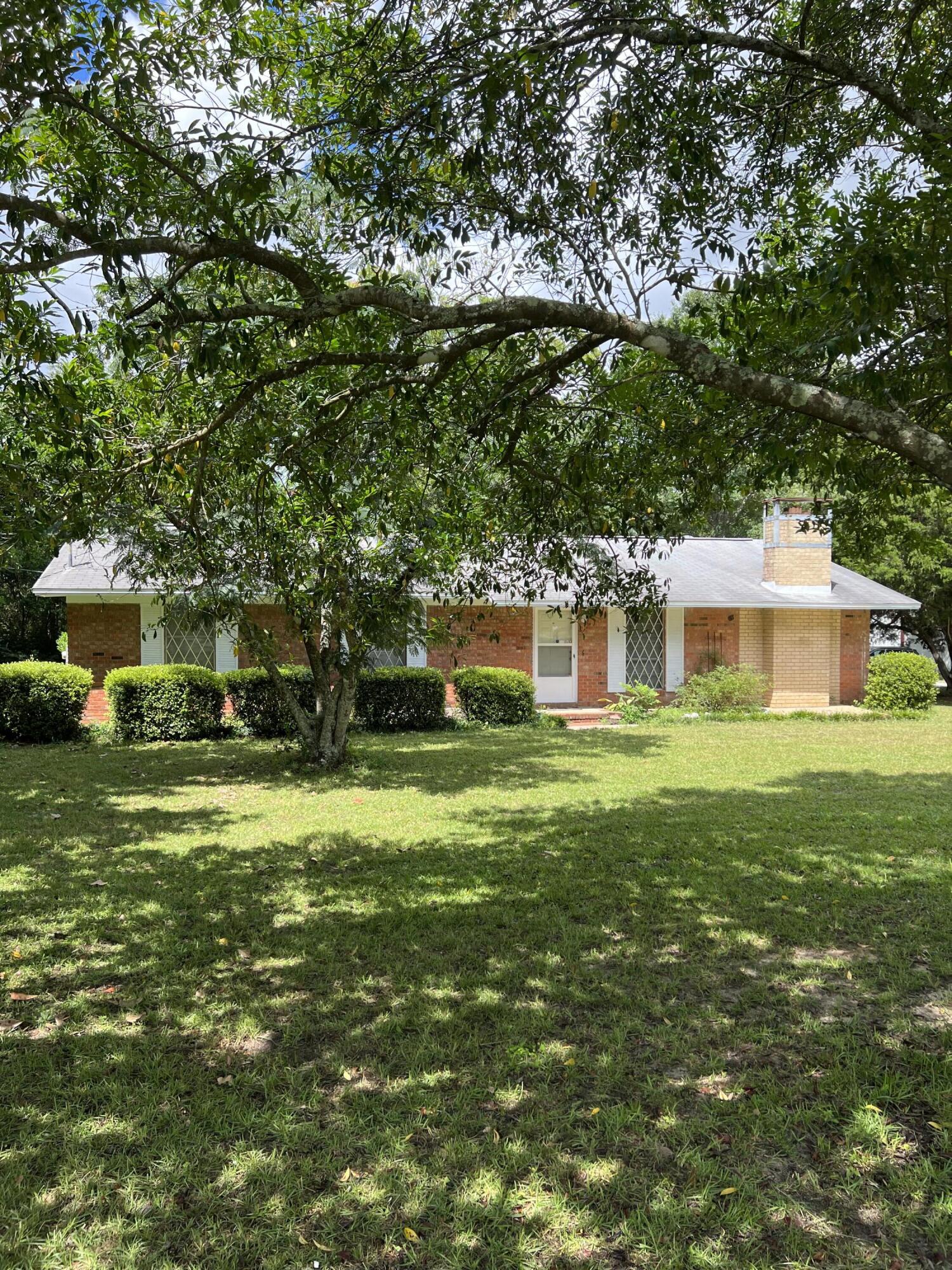 County location on 1.37 acres.  Ranch style 3 bedroom, 2 bathroom brick home with large carport and large 30 x 50 metal shop building with three additional workshops/sheds.  Mostly level lot with some fencing in front and rear.  House will require some updating and minor maintenance. Roof less than 10 yrs old.  Plenty of parking for multiple vehicles, boat and RV.