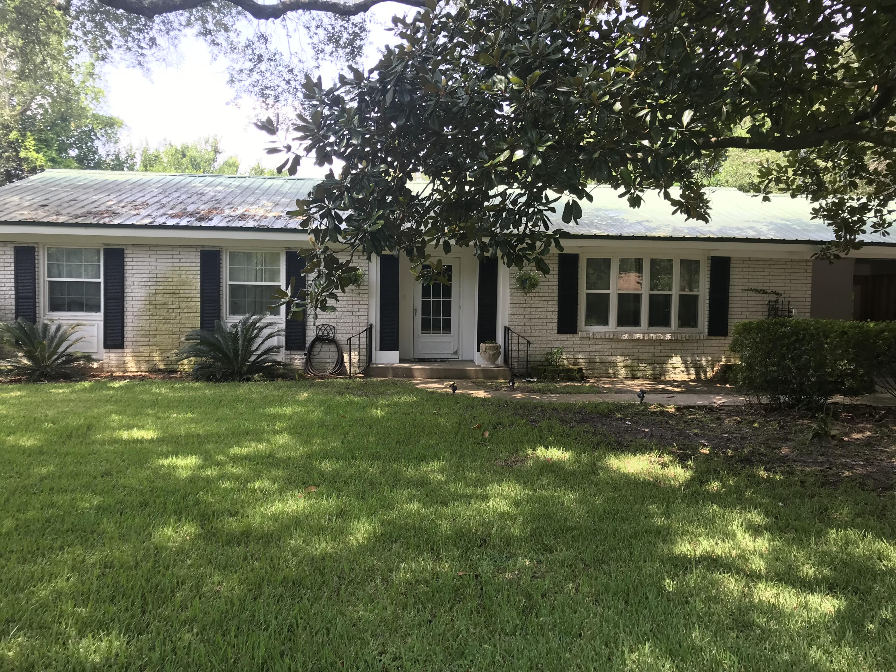 Home is available for showing 1/3/22. Available for Move in January 7th. Large Beautiful lot heavy with Magnolia and Live Oak Trees and azalea bushes. Newer kitchen and bathrooms. Floors are original hardwood throughout the house; tile in the kitchen and bathrooms. Main bathroom has double walk in shower. Open kitchen design into the dining area that could be used as family room and dining area because it is oversized. Living room also has extra area for entertainment systems. Backyard is an amazing outdoor space complete with bar, wall mounted tv, and a deck for all of your entertaining needs. Text 850-797-0681 for more information Small dog under 20 #'s allowed. No Cats.