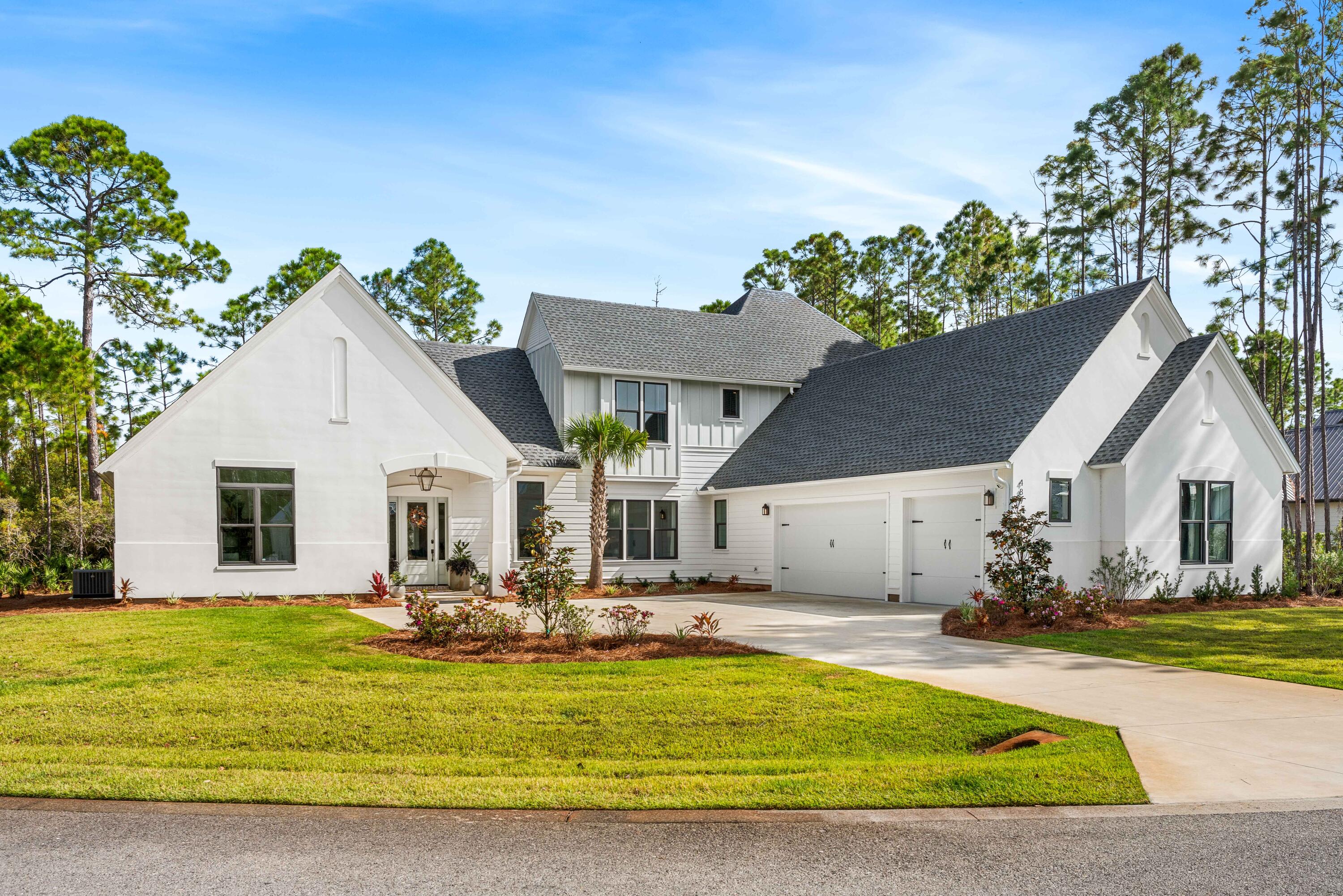 Welcome to 489 Hideaway Circle, an exquisite like-new 2023-built masterpiece nestled on a serene half-acre lot within the prestigious gated bayfront community of Seclusion Bay in Santa Rosa Beach. This luxurious home boasts 5 bedrooms, including both upstairs and downstairs guest suites, offering exceptional privacy and comfort for family and friends. Thoughtfully designed with high-end finishes, this residence features white oak hardwood flooring, quartz countertops with waterfall edges on the island, and premium stainless steel appliances. The main floor includes a separate wet bar and a butler's pantry - Perfect for entertaining. Upstairs, a secondary gathering space on the landing creates a versatile retreat, while pops of designer wallpaper throughout add a touch of personality and warmth. Enjoy movie nights in the dedicated theater room or take advantage of the expansive backyard with ample room for a custom pool. Abundant natural light floods the living spaces, creating a peaceful and welcoming atmosphere throughout. And the three-car garage even includes a conditioned storage closet for added convenience. This low-density, family-friendly community is comprised of only 53 estate-sized lots, ensuring a quiet, exclusive setting. Residents in Seclusion Bay enjoy access to a community dock on the Choctawhatchee Bay for fishing, paddle-boarding, and kayaking, along with mesmerizing bayfront sunsets- ensuring MAXIMUM family memories. Centrally located near 30A's renowned beaches, top-rated schools, and scenic state parks, this home delivers the absolute best of coastal living.