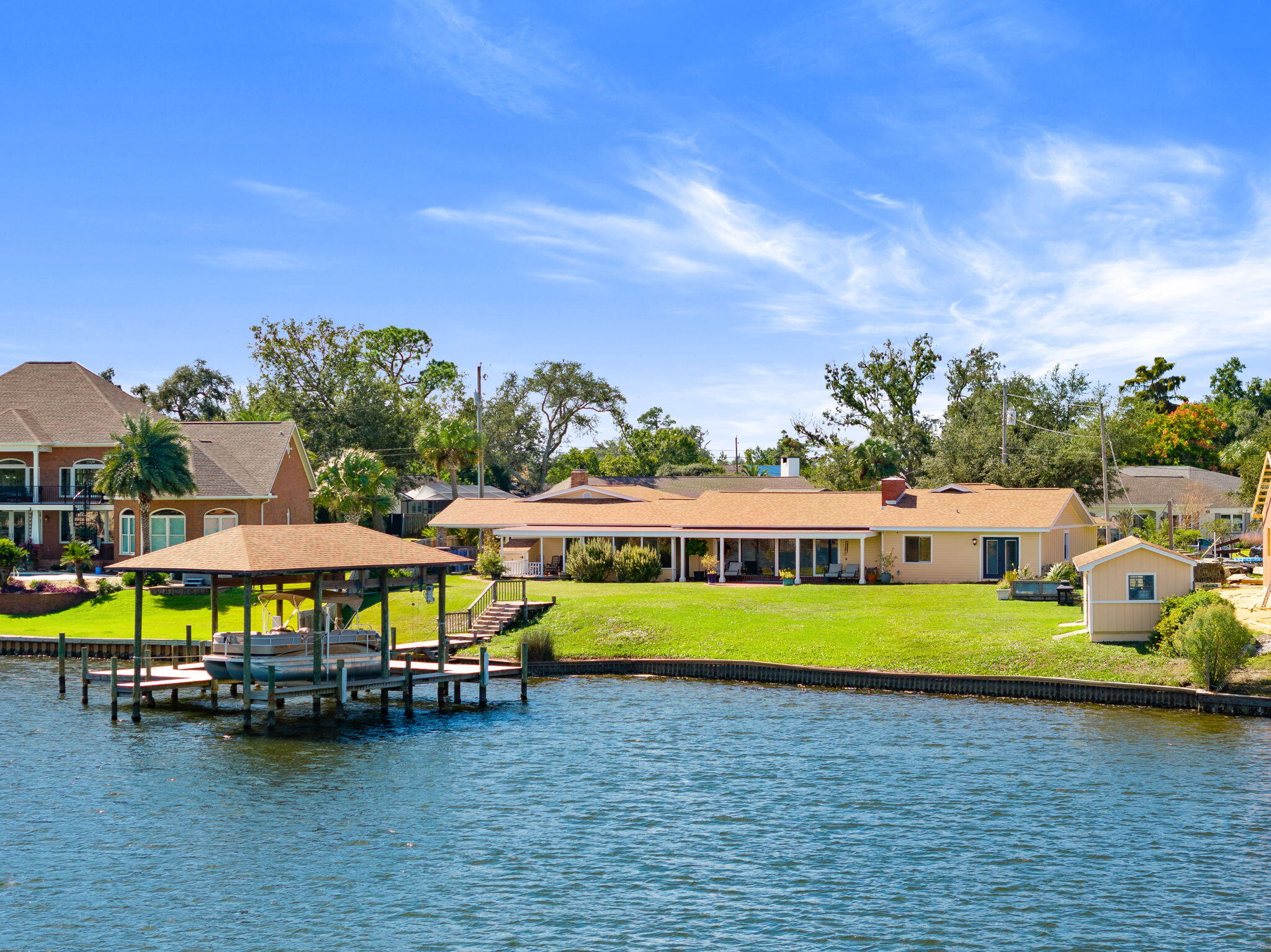 This beautiful 3-bedroom, 3-bathroom home offers the best of Florida living with STUNNING WATER VIEWS and DEEP WATER ACCESS along with EASY ACCESS TO THE BAY. Located in the Pretty Bayou neighborhood, this home features an open floor plan great for entertaining. Enjoy the serene views of the bayou with 2 covered porches. You have your own PRIVATE DOCK WITH A BOAT LIFT. The large backyard offers ample space for outdoor activities and potential for a pool. The master suite is a true retreat with views of the water and a walk in closet. This house is close to St. Andrews and downtown Panama City for restaurants, shopping and more. It is also just a short drive to the beach! This house is perfect combination of comfort, convenience, and natural beauty. Schedule a tour today!