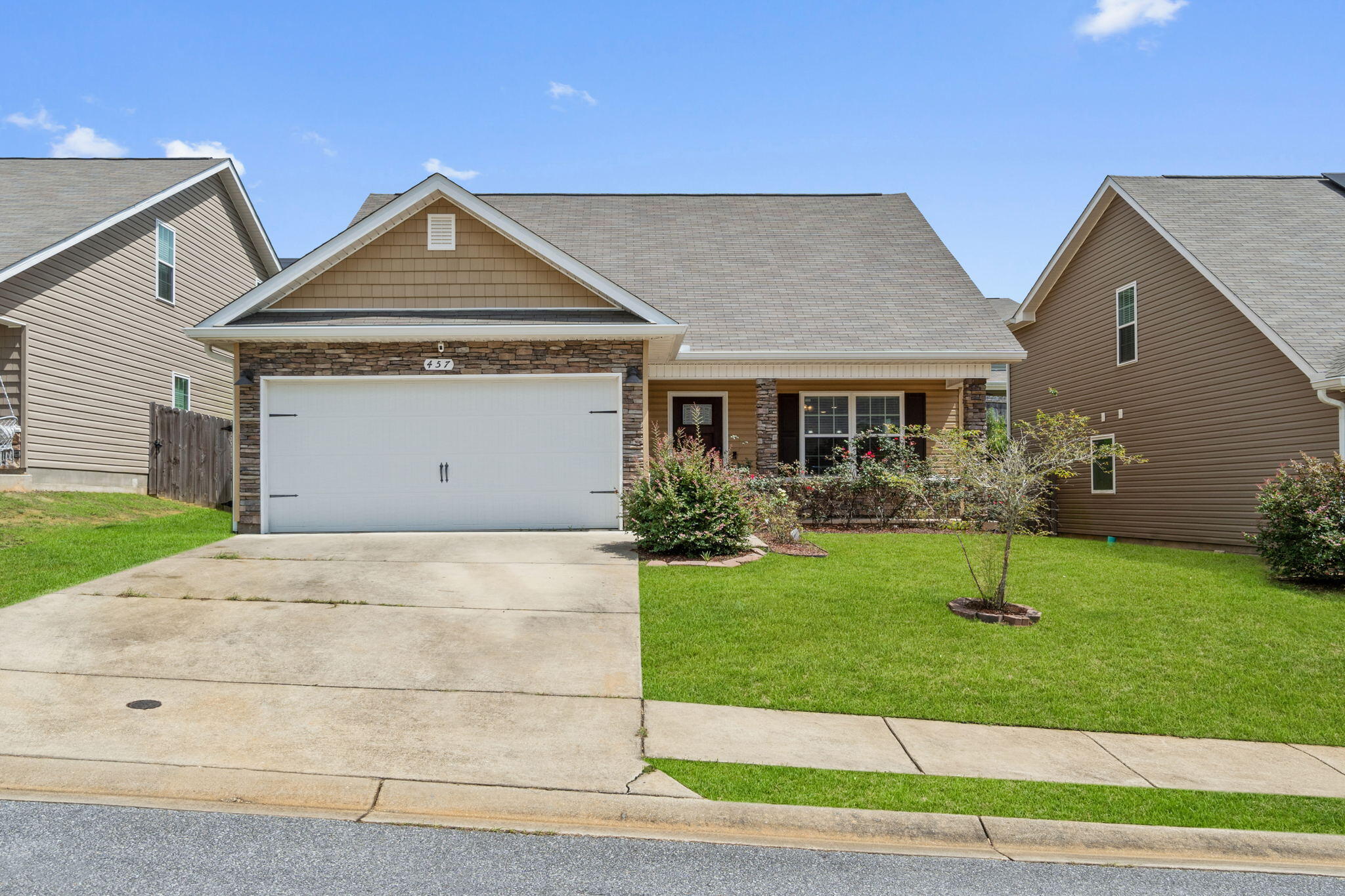 Welcome to this fantastic FIVE bedroom home in Stillwell Estates! Walk past the newly sodded front yard to the covered front porch and into this fantastic open floor plan. Downstairs you'll find the master bedroom (along with a half bath off the dining space) and upstairs are 4 bedrooms with a shared bathroom with double vanities! The spacious living room features wood look luxury vinyl plank flooring that extends throughout the entire downstairs including into the kitchen and master bedroom with tile flooring in the bathrooms and interior laundry room which leads to the two car garage. The kitchen is well appointed with stainless steel appliances, white cabinets, drop down pendant lighting, and a separate pantry; and the eat-in dining space has a wood accent wall. Relax in your owner's  suite and the bathroom which features lovely double vanity sinks, bronze finishes, a walk in shower, and a separate garden tub. Upstairs are those fantastic 4 additional bedrooms all with TONS of closet space to meet all your needs! Outside is a fully fenced in backyard where the HOA cuts your yard and edges the grass every two weeks (front and backyard!). Enjoy a fantastic and convenient location, welcome home!