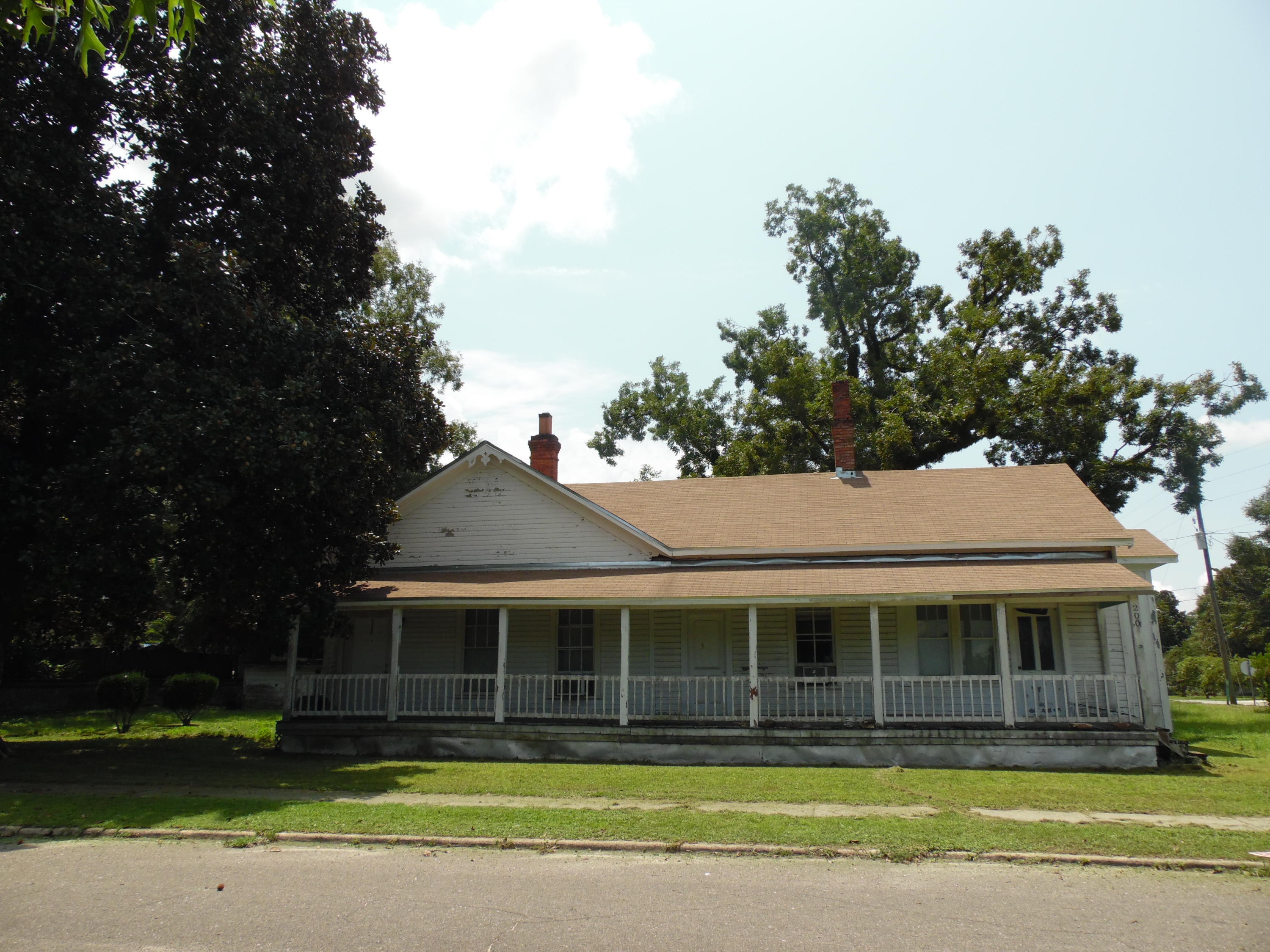 Have you ever wanted to own Vintage home to restore that has that has tremendous character ...this is it! Now you may own your own piece of DeFuniak Springs history with this charming home. It is located on three city lots with fully grown pecan, oak and magnolia trees. The total sf is 2,898 with a base area of 1,950: 3 bedroom 1 bath. This home was one of the first homes built in Historic DeFuniak Springs. According to the abstract of title the property was originally deeded to the Pensacola and Atlantic Railroad Co. It was used to house workers who were working on the railroad we were told. Over the years it has been modified. SELLER IS REMOVING WINDOW AIR UNITS AND APPLIANCES
CLICK ON MORE TAB TO READ MORE: It has a large 8x52' front porch across the entire front that invites you into a large living room  14x17 with Parlor/family room 14x17' and foyer area12x8'.  A large kitchen/dining room is at the back of the home...with breakfast bar.   It should easily hold a formal dining room suite, plus area for breakfast nook table set.  Seller has installed a new shingle roof and made other repairs.   It is located  just 3 blocks from Lake DeFuniak. Also has large detached storage building.  Easy to view...