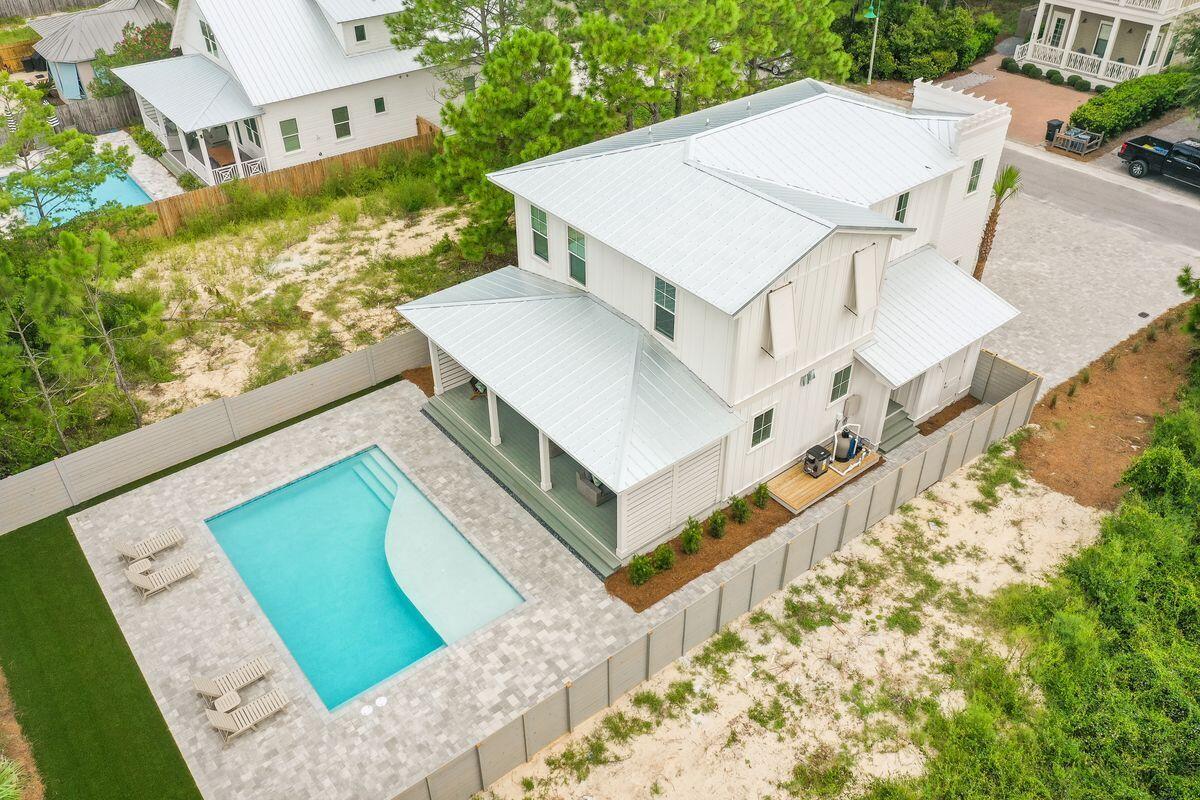 Under contract - accepting back ups. Welcome to ''Coffee and Starfish'' - a truly remarkable 4-bedroom, 3.5-bathroom property located in the heart of Seagrove Beach, Florida. This stunning new home boasts a luxurious interior and a prime location, being just a few steps away from the soft, white sand beaches of 30A, providing easy public beach access. With a capacity to comfortably sleep up to 10 guests, this home is perfect for large families or groups of friends.
Upon entering the property, you are greeted by an exquisite and spacious living area that is open-concept, with the kitchen, dining, and living room all perfectly designed for entertaining. The kitchen features brand-new premium appliances and ample counter space for meal prep on the five-burner gas range.  The living room provides plenty of comfortable seating andlarge smart TV with a SONOS surround sound speaker system. Adjacent to the living area, you'll find a convenient wet bar and beverage fridge, perfect for mixing up refreshing drinks after a day at the beach.
This home boasts four well-appointed, spacious bedrooms, each one meticulously designed with your comfort in mind. The first-floor primary bedroom features a king-sized bed, a private bathroom with a walk-in shower, and plenty of closet space. On the second floor, the primary bedroom features another king-sized bed, a large walk-in closet, and a private en suite bathroom with a walk-in shower. The second floor bunk room offers four custom-built queen beds, each with its own power outlet and storage nook. Additionally, there is a king guest bedroom with beautiful board and batten accents. Both the bunk room and guest bedroom share a spacious bathroom with a double vanity and a shower/tub combination.
Step outside, and you'll find a beautiful covered porch that runs the length of the home, with plenty of space for lounging and dining. The porch also features an outdoor TV for your entertainment needs. The large, heated private pool in the backyard is the perfect spot to cool off after a long day at the beach. At the front of the home, there is a welcoming front porch with comfortable lounging chairs, offering a relaxing spot to enjoy your morning coffee. The property also has a spacious driveway that can accommodate up to four vehicles.
In addition to the many amenities of this magnificent home, guests can also take advantage of the Village of Sugar Beach's amenities, including a community swimming pool, as well as the home's shed, which is stocked with beach gear including chairs, umbrellas, towels, cooler, cart, and sand toys. This exceptional property is also within walking distance to a variety of local shops, stores, and dining options.
Don't miss out on the opportunity to make this incredible property your own. Contact us today to schedule a showing!