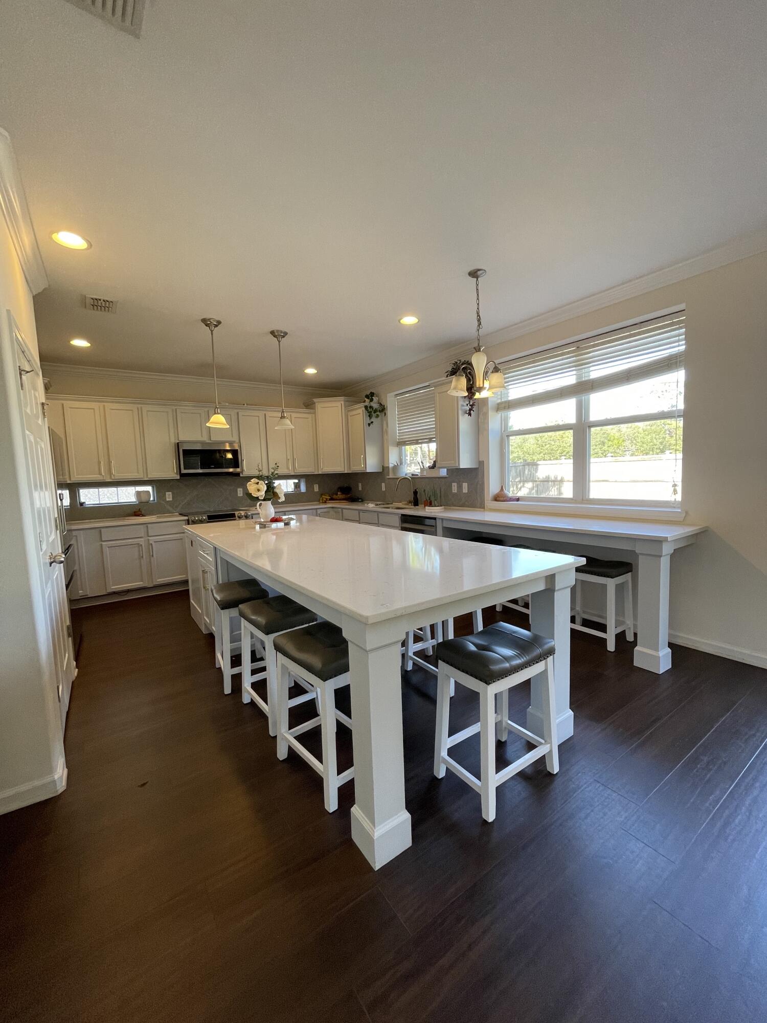 Lovely 3 bedroom home with a large corner lot, and fenced yard just outside the gates of Hurlburt! The kitchen is a chef's dream with custom quartz countertops that extend the length of the kitchen, and a 10' custom center island that can be used as table. The home enjoys lots of natural light, and has dark vinyl wood flooring throughout. The spacious Master ensuite provides a sitting area, and the Master Bath has a Garden Tub, Tile Shower, and Double Vanity. The bonus area upstairs is ideal for a home office, reading nook, or play area. There is plenty of storage. This place  is ideal for entertaining! New AC in 2022, new hot water heater 2023. Commercial garage floor. No smokers, No pets, please.