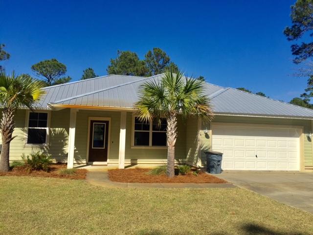 Price Reduced!! 1.5 acres in the heart of Santa Rosa Bch! Florida style cottage w/hardiplank siding/metal roof is in excellent condition and ready for occupancy! A private tree lined pond on the roadside of the property creates a quiet privacy buffer. Concrete driveway winds down to the home and outdoor storage bldg. Plenty of land for storing outdoor equipment/boats/rv's. Split floor plan offers privacy. The great rm/dining rm provides an open concept w/10' ceiling and has many windows to provide plenty of natural lighting. Neutral tile flooring is throughout the home w/carpet in the 3 bdrs only. Granite counters in kit/baths. Upgraded oil rubbed bronze fixtures throughout. Kit has ssteel appliances, tile backsplash and raised breakfast bar. Mbr has 2 walk in closets, trey ceilin Mbath has dbl vanity sinks, granite counters, tile shower w/glass door, and a separate garden tub w/tile surround.  The large back porch is screened and overlooks the fenced in backyard and pond.  Sprinkler system w/well.
Home is on city water and sewer.