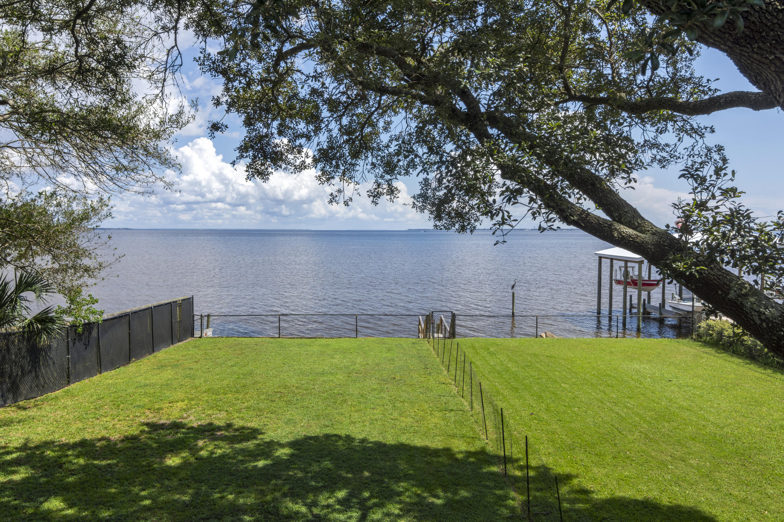 Hard to come by waterfront home in Elliot Point! Endless  water views over the Bay.  Upon entrance you are greeted by lush and tropical landscaping with an abundant amount of parking space for all your vehicles and guest. Two story home with 2500sqft of living space.  Two master suites! Master on second floor with lockout/private entrance if needed.