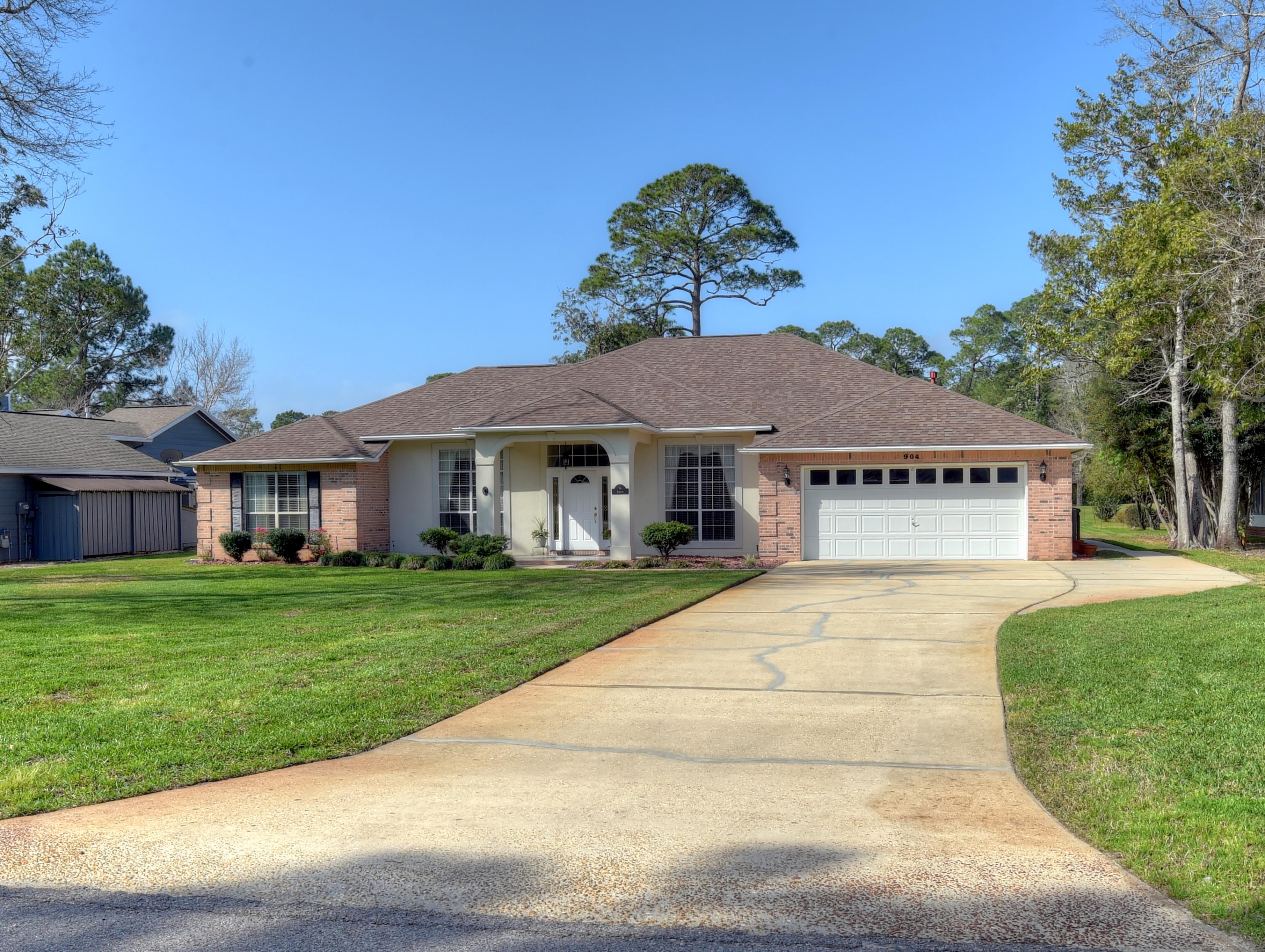 Pristine home located on the 8th green of Bluewater Bay on a beautifully landscaped lot. This fabulous home offers a very open floor plan is an entertainers delight! As you enter the home your eyes are drawn to the Hickory wood floors and 10' ceilings throughout the main living area complete with crown molding. Formal dining room on your right and a study with custom built-in lighted book cases, desk, and file cabinets on your left. The open living space offers a gas fireplace with custom built in lighted cabinets on either side with pull out drawersgreat for all those electronics! This split floor plan features 2 generous size bedrooms and bath on one side while the large master bedroom and large master bath located on the other with a separate shower, granite countertop double vanities, soaking tub and a large walk-in closet.  Kitchen features stainless steel appliances, pull out drawers, walk-in pantry with a fabulous granite and large breakfast bar.  The breakfast area also boasts matching cabinets and granite in the built-in buffet.  A very large space leads to the family room that could be used for many things... Out the back door is entertainers central!  Large 23x13 covered lanai leads to a sparkling guanite salt water pool with a heated spa overlooking the golf course....there is even a baby gate to keep little ones away from pool when enjoying time outside.  I'm sure you will agree when you view this spectacular home... Laundry room also features a laundry sink and cabinets. The oversized 2 car garage even offers a separate double door entrance which is perfect for a golf cart and plenty of parking in the oversized driveway. Other features...custom blinds and drapes, updated bathrooms, lawn irrigation system with 4 sections for yard and 3 sections for plants and shrubs around the home. The only thing it needs is a new family to make wonderful memories...