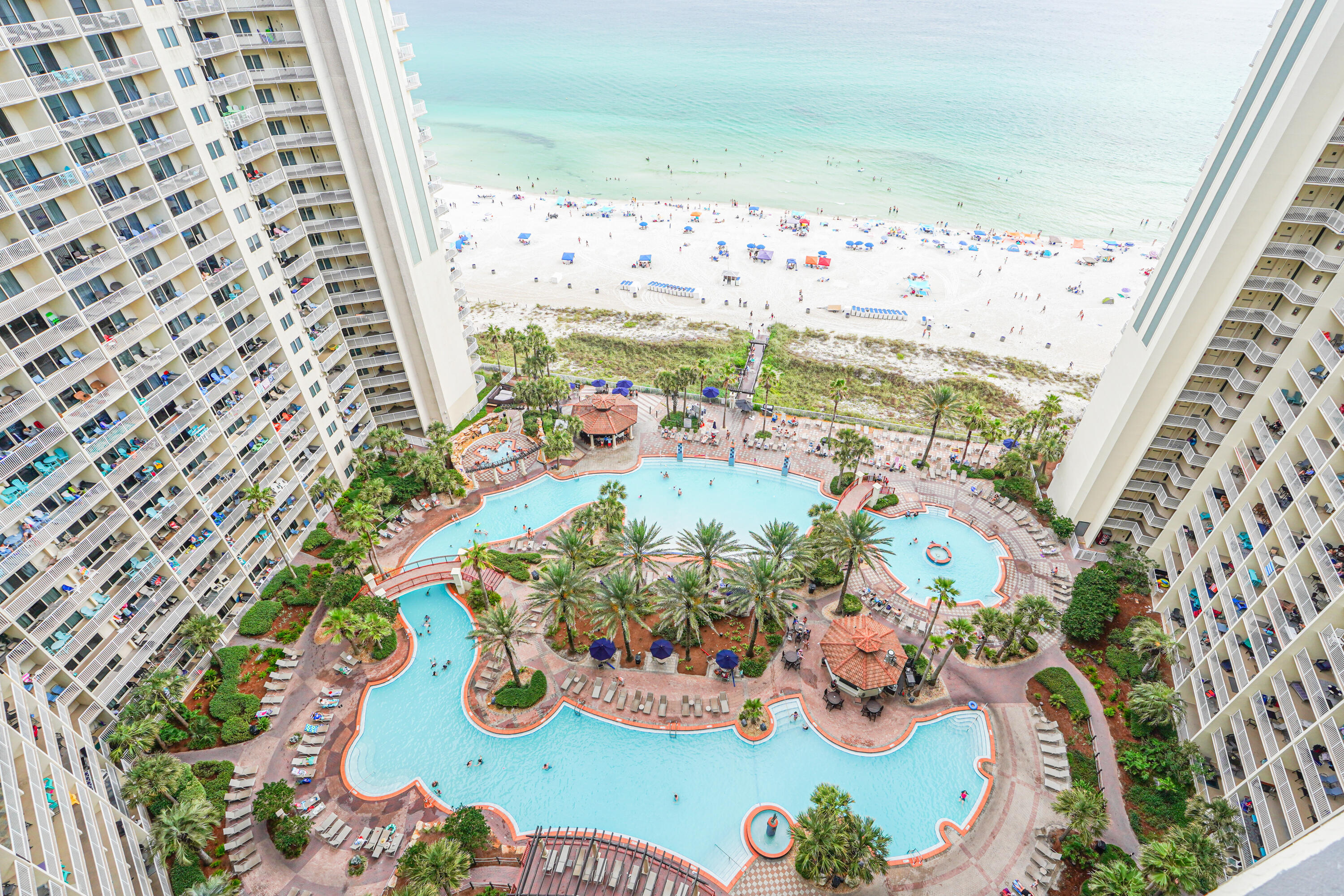 Welcome to Unit 2015 at Shores of Panama, a beautifully furnished 2-bedroom, 2-bath condo, with a dedicated parking spot offering stunning views of the Gulf of Mexico and the resort's iconic lagoon-style pool. Located in one of Panama City Beach's most desirable beachfront communities, this move-in-ready unit is the perfect blend of coastal comfort and resort-style living.

This spacious condo features an open-concept layout with a bright, airy living area, brand new vinal flooring throughout, and a large private balcony, perfect for soaking in sunset views. The fully equipped kitchen includes granite countertops, modern appliances, and a breakfast bar ideal for entertaining. The primary bedroom boasts direct balcony access and an en suite bathroom, while the second bedroom and additional full bath provide ample space for guests or family. Fully furnished with stylish coastal décor, this unit is turn-key and rental ready.

An assigned parking space is included- a major bonus during peak season.

Enjoy unmatched resort amenities:
Gulf-front pool & hot tubs
Indoor pool
Fitness center & spa
Tiki bar, beach access, and more!

Whether you're looking for a vacation home, investment property, or full-time beach residence, Unit 2015 delivers location, luxury, and lifestyle.

Don't miss this opportunity to schedule your private tour today!