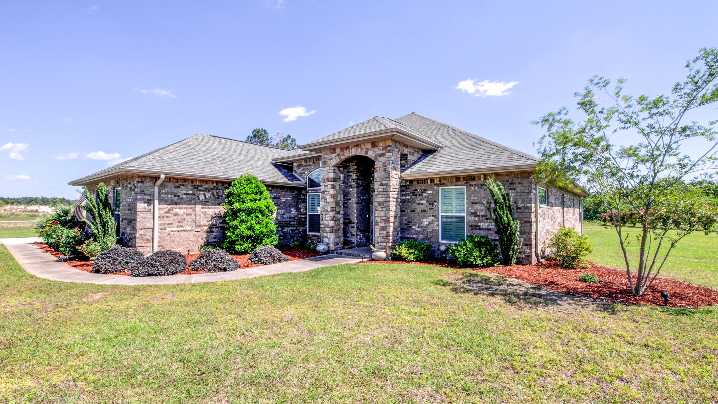 Welcome to this Outstanding 3bdrm, 2 -1/2 bath, with a Flex room/Office. This spacious, approx 2675 sq ft home was Custom Built on a .62 acre lot in 2013 by Chris Ritchie Construction in the highly sought after 450 lot Windswept Estates Community. The development currently has 5 phases of 401 lots developed with 49 additional lots planned in phase 6 on the books in Walton County planning.
The home features 9/11/13 foot ceilings, Tile floors throughout with Carpet in the bedrooms, custom crown molding, gas fireplace and upgraded light fixtures & ceiling fans enhance this amazing home.
The Kitchen includes Custom Cherry Cabinet from Pinnacle Cabinets in Pensacola, Stainless Steel GE appliances with a gas 5 burner cook top, double Electric ovens, Built in Microwave/Convection oven, a 18 bottle Wine Cooler, Travertine tile back splash and custom Quartz counter tops.  A large Center Island/Bar overlooking the great room and a convenient walk-in pantry finishes out the kitchen. Solar tubes let in natural light.
The Master Bedroom includes an en-suite bath with his and hers vanities, oversize double shower, oversized whirlpool tub and walk-in closet.  
The Guest Bedroom includes a walk-in closet, a large bath with double vanities and a tub shower combination
A Large laundry room with plenty of storage, built-in ironing board and a deep utility sink is located right off the 3 car garage.
 Enjoy the 24' x 14' paver patio with screened Lanai and 9' x 20' covered porch overlooking the backyard and fenced play area. 
This energy efficient home has low E windows, a Tank-less Gas Water heater, Custom Plantation shutters and a 250 gal in-ground propane tank.  
This Beautiful home is part of a 750-acre gated golf course community offering a Florida lifestyle that includes unspoiled surroundings and a host of recreational opportunities.  Sparkling white sandy beaches and turquoise waters of the Gulf of Mexico are just 30 minutes from the door. The real beauty of this home is the opportunity to enjoy the outstanding amenities and outdoor activities offered within this premier community. Play a challenging round of golf at the Windswept Dunes Golf Club in the morning, have lunch with friends and spend the afternoon on the beach relaxing in the sun or just take a leisurely Golf Cart ride around the 7 miles of Community Roadway.  If you prefer hiking, cycling and wildlife spotting then the nearby Pine Log State Park on Long Leaf Rood in Ebro, Fl 32437 or one of the other numerous State Parks in the area is right up your alley.   Neighboring Choctawhatchee Bay offers a host of water sports, fishing and boating opportunities via the Freeport Marina located 5 miles away, but you don't have to leave the community to have fun. There's a large swimming pool and clubhouse on site along with a playground, two tennis courts and a basketball court for challenging neighbors to a friendly match. Centrally located in Freeport, this community is a short drive from boutiques, restaurants and entertainment at Seaside, Rosemary Beach and 30A while still within easy reach of Destin, Panama City, Eglin AFB via SR-20 and I-10 is just 15 miles to the north.

  The Septic tank was pumped in June 2017 due to an anticipated price increase. 

Make this home yours!