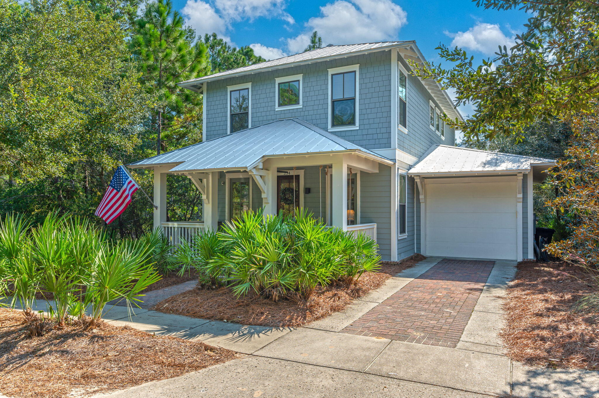 Welcome to Forest Lakes. Beautiful lake front Florida style cottage in the heart of Blue Mountain Beach. This fully furnished home features an open floor plan with a first floor primary bedroom. Hardwood floors, oversized molding, gas fireplace, quartz countertops, shaker cabinets. Stainless steel appliances including gas stove. Large lakefront first floor screen porch and large lakefront 2nd floor covered balcony. The screen porch leads out to the backyard facing the lake, with it fenced in. Beautifully landscaped with brick paver patio. Attached garage, with lots of storage.