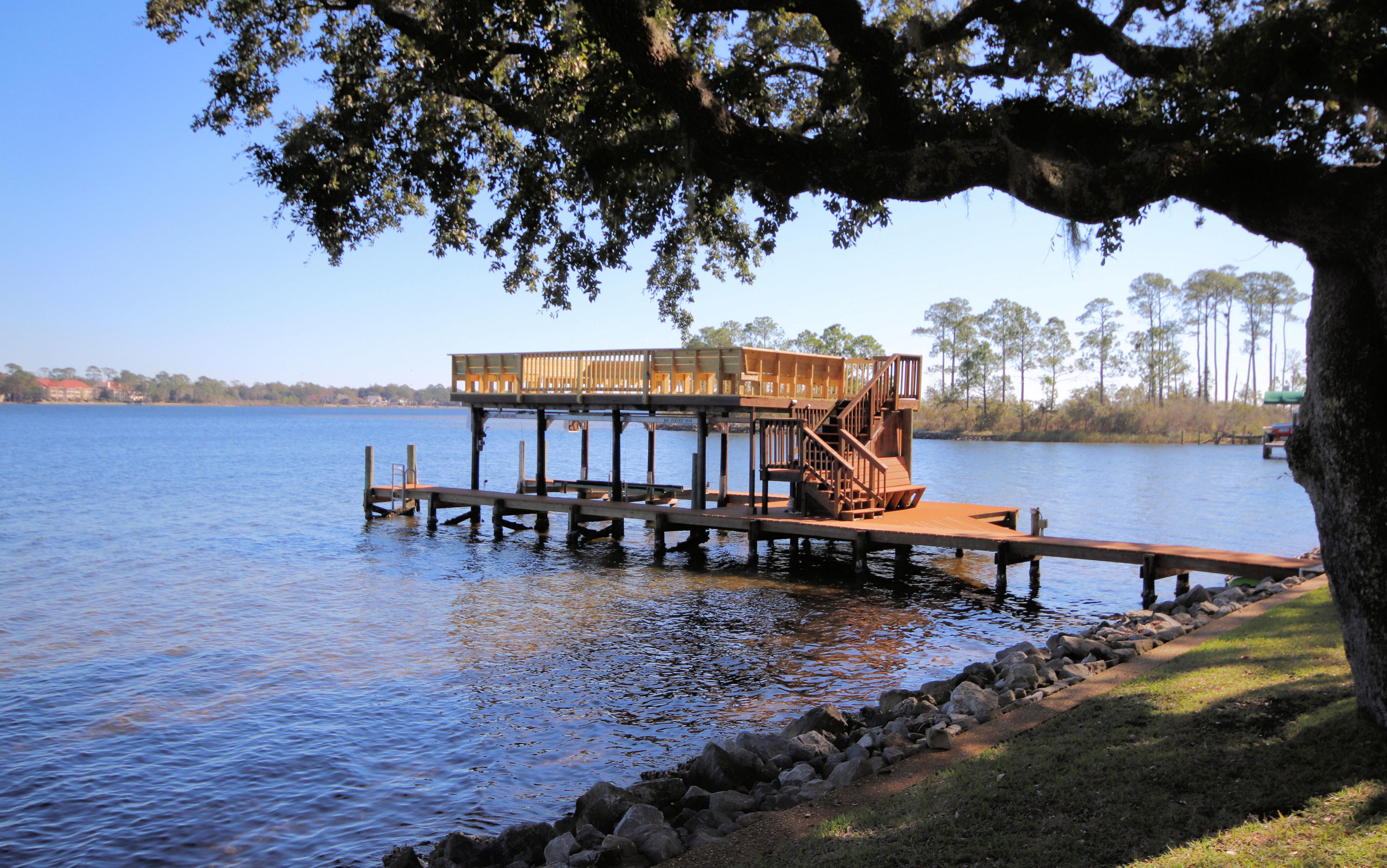 This house is all about the views! Stunning location with 200 feet on Rocky Bayou that looks out to Bluewater Bay and the Choctawhatchee Bay. This amazing home sits on a large manicured lot with beautiful landscaping and Spanish moss draped live oaks.  Pictures do not do it justice. The dock is a show stopper with an upper deck to sit and enjoy the beautiful Florida sunrises. Below the sundeck is a 12 ½ wide boat slip with lift. Inside the home has 2 living areas, 4 bedrooms , 3 baths, large laundry room, lots of storage and a sauna!.  The living room , dining area, kitchen and master bedroom overlook the back garden and water. The house sits back from the road for added privacy and has a large  paved circular driveway.  
 Yard maintenance is included . NO pets, NO smoking.