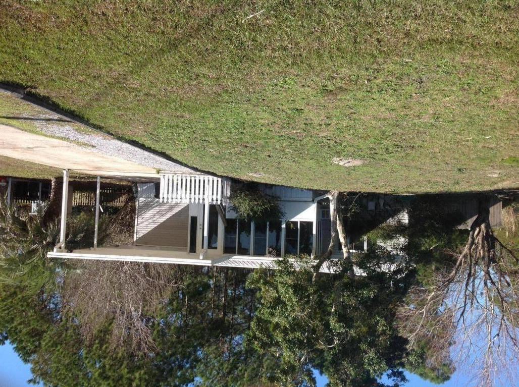 Wonderful LOCATION on the South side of highway 98. Only 1.5 mile to Ed Walline Beach Access and Gulf Place. Close to Publix, dining, beach, shopping. Privacy fence new large back deck. Freshly painted. Large FL room heated and cooled on back and FL room on front of house has added an additional 400 + sq. ft. to the house, . New fridge and stove,metal roof 2012, HVAC 2021, water heater 2021 master bath updated 2013, guest bathroom updated 2014, 140 MPH rated windows all the way around the home, new flooring in kitchen, bathrooms and closets in 2017.  Agent is owner of property. Great community. Florida room has a closet so can be used as a 3rd bedroom.