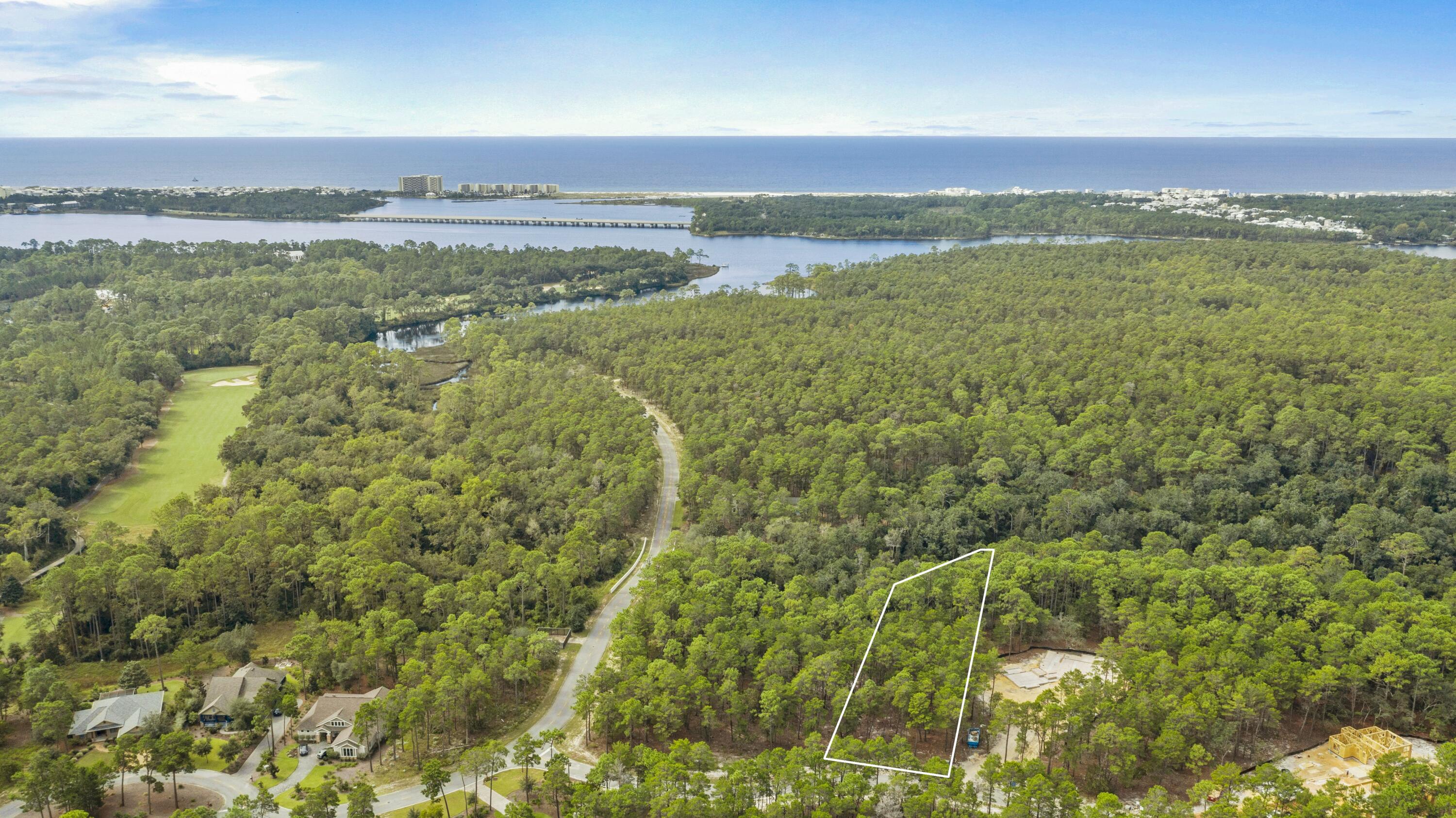 Begin dreaming with this wooded .56 acre B lot in the gated community of Wild Heron, a 734-acre Coastal Sanctuary, located on the shores of Lake Powell, Florida's largest coastal dune lake. Designing and building your own getaway, vacation home or year-round Florida residence is reserved for the independent spirit who wants to create a personal refuge. Customize this homesite and incorporate the classy coastal Craftsman style this premier community embraces. This lot backs to a conservation area, is high and dry in flood zone X and on a small quiet street. You will enjoy world class amenities overlooking Lake Powell like the fitness center, heated pool and hot tub, a boat house for storing kayaks and paddle boards, community dock, fire pit and gathering area with fireplace. A revered oak-filled family park that features many types of fun filled family events are a favorite, along with 24 miles of walking and bike paths linked to the amenities for the convenience of those who call it home. The white sandy beaches of the Gulf of Mexico await you only a short kayak paddle away across the lake. 30A, Rosemary and Alys Beach, are a few minutes' drive to world class dining, grocery stores and shopping as well as Pier Park in Panama City Beach. Golf club and beach club memberships are available to purchase as well as access to the world renowned Greg Norman Sharks Tooth golf course, club house and hydro court tennis courts onsite right here at Wild Heron. Buyer should verify all measurements and data. 
Don't let this opportunity pass you by. Call today.