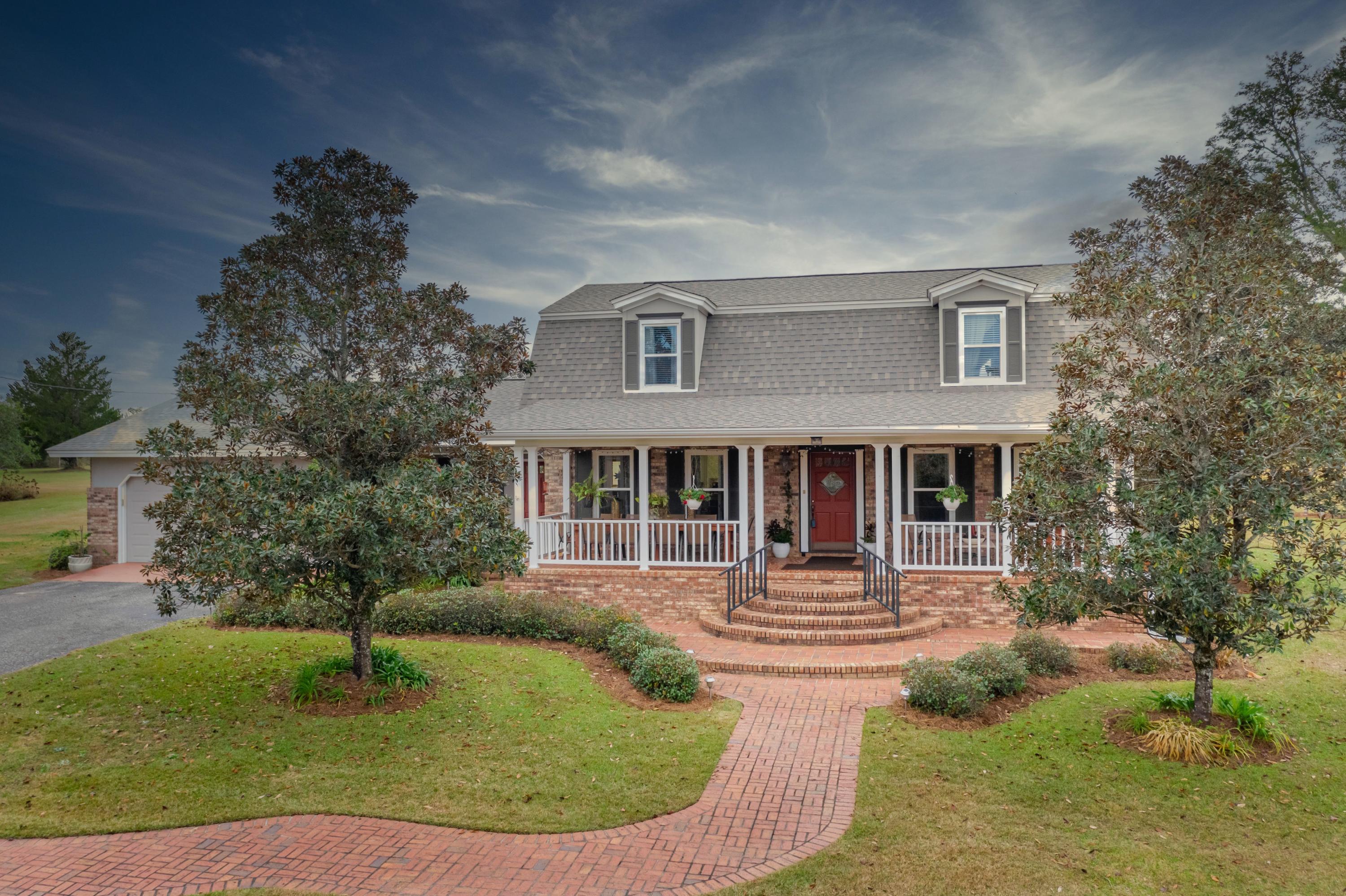 SELLER TAKING BACKUP OFFERS.This is the beautiful home and 19 acres you've driven by and admired for years! The breathtaking tree lined paved driveway guides you to your new home in the country, but just close enough to the city. The impressive sized front porch might make you wish you had a glass of sweet tea/etc. and a book to relax with. Enter the foyer area to be impressed with all in site. Your new wood floors will lead you to the right side which is the Boar's Den, aka, the den. To the left is the gorgeous dining room that adjoins the remodeled kitchen. Between the two rooms you are awarded an eat-in bar with storage galore, topped with granite counters, and probably has enough seating area for all your best friends for a fun night of entertaining.  Move into the Princess Parlor, aka, the living room, to cozy up to the hearty fireplace and views of your glorious land. Off the parlor you have an oversized laundry room with office space, an abundance of storage, and a full bath. Across the way you will find the first master bedroom next to the full bath that includes a new glass enclosed shower/bath combo. Feel royal with bidets in all the bathrooms. Upstairs is impressive with 3 bedrooms and a full bathroom. One of the bedrooms is a second master suite with a full bath that includes a separate guest entrance (unless you lock that door). Also has an attached vanity room. Here's some of the new items: Roof 2019, one of the two HVAC units 2018, windows 2016, downstairs remodel 2014, exterior paint 2017, microwave 2016, glass tub/shower enclosure in downstairs master bath 2017, weather stripping on all doors 2020, porch ceiling fans 2018, wrought iron rails on front porches, and irrigation system updated 2017. Bonus features: back entertainment patio area that spans almost the entire length of the home, termite bond in place, pole barn, garden spot with electric fence, chicken coop (you might negotiate some chickens), 2 car garage, and a very impressive barn with an attached but separate cooled summer kitchen and living room area. The location is perfect as the home is within 2.5 miles to the hospital, shopping, dining, and schools, around 5 miles to Falling Waters State Park which is home of Florida's tallest waterfall, and within around an hour to the international airport and the sugar white beaches of the Gulf Coast. Call...don't let someone else take your home!