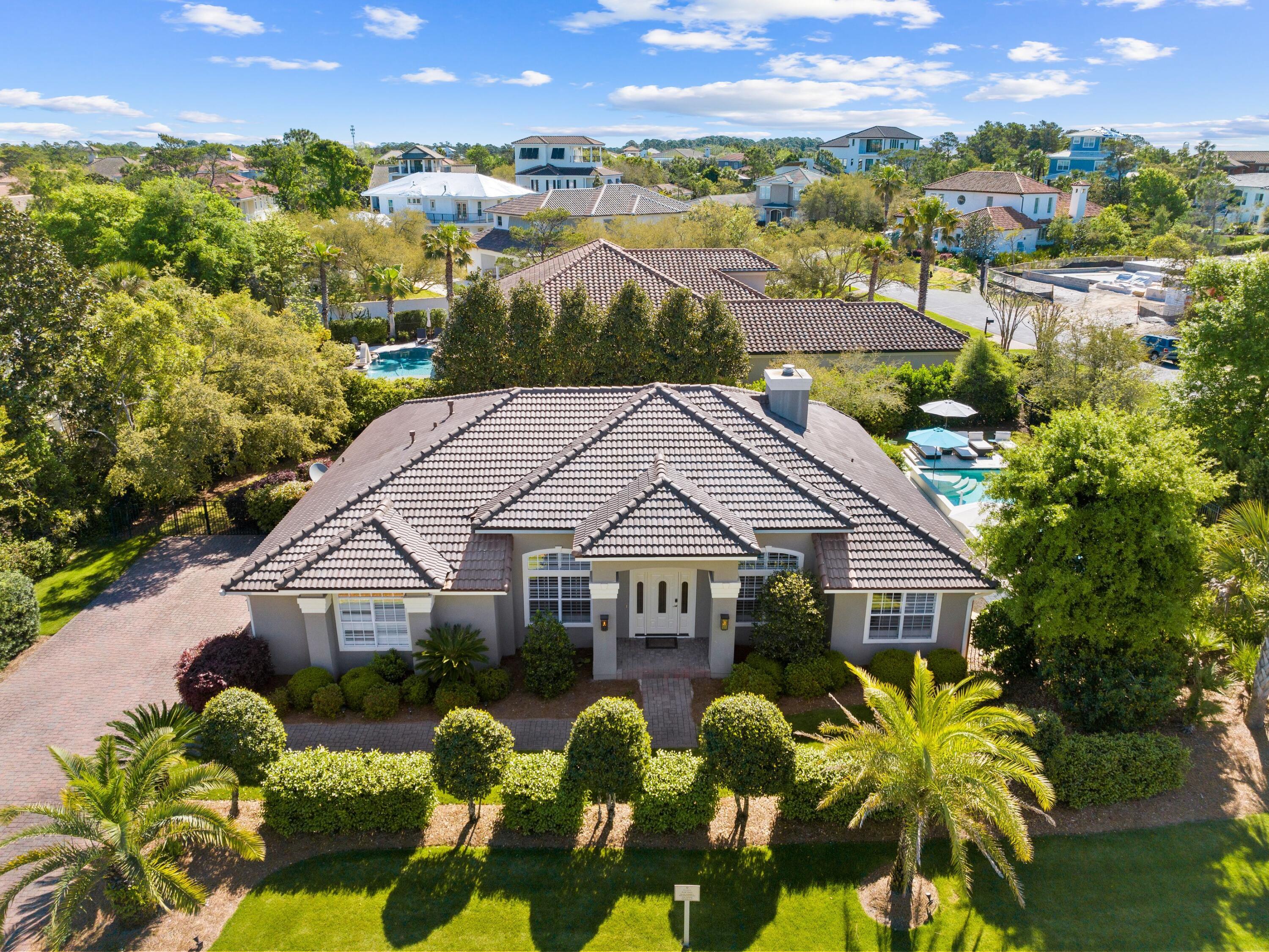 Comprehensively renovated and expanded home in BellaMar close to neighborhood private beach access.  This fully furnished coastal residence will exceed expectations, inside and outside, with an expansive, heated pool and new roof added in March 2024. Occupying a generous corner lot, this impressive home has a lengthy driveway and a two-car garage. The pillared entrance porch opens into a huge contemporary living space that will take your breath away. New flooring throughout the home provides a backdrop for the neutral decor and modern furnishings arranged in this spacious home. There's a dedicated office space on one side and a built-in wet bar with its own wine cooler and ice maker. It's perfect for serving drinks to guests before heading into the separate formal dining area. The well-planned kitchen is an epicurean dream with full-height cabinets, sleek stainless appliances and sweeping quartzite topped counter on the kitchen island/breakfast bar. It's equipped with a six-top gas range, double oven, Samsung digital refrigerator, built-in microwave and more. A wall of fully retracting windows extends the bright living area out into the newly landscaped yard, delivering a seamless indoor/outdoor lifestyle. Take a dip in the jetted heated 15 x 30 swimming pool, which was added 2016 and recently been converted to saltwater. Other upgrades include a HomeWater filtration system, new UV air filtration and dehumidifier system, a backup home generator and new HVAC in 2022. Situated in the beautiful gated rental-restricted community of Bella Mar, this luxury beach home is close to the gate just a short hop from Gulf Place shopping and dining. The neighborhood beach access is nearby for enjoying morning walks with occasional sightings of dolphins, pelicans and wading birds. For discerning buyers looking for a new home with that little bit of extra panache, this could be a perfect fit.