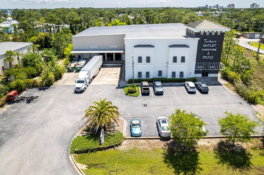 This subject listing offers the Tusker's warehouse, excluding the freestanding retail building fronting Highway 98 (freestanding retail building also available via MLS 978842). This rare assemblage of prime retail, showroom, and warehouse does not currently exist in the local market, which is adjacent to the synergistic retail nucleus of Silver Sands Premium Outlets and centralized to all the local mixed-use districts, successfully drawing population from all local peripheral sub-markets, including but not limited to Destin and Scenic 30A of Santa Rosa Beach, Florida. Fronting Highway 98 in Miramar Beach, nearly 50,000 vehicles pass by its 196 fronting feet daily, which ingress and egress lures the traffic into the retail facilities through the convenience of... the traffic light at N. Geronimo Street and Highway 98. The current owner has committed significant capital to renovate both buildings, which even includes approximately $300,000 for new escalators to service the second floor of the main showroom.  Parcel 1 contains a two-story building, oriented on ±1.18 acres, hosting prime retail and showroom space, as well as private offices, collectively measuring ±26,893 conditioned square feet. There is a 3rd floor that accommodates a spectacular executive office, accessible via a private & secured "floating" staircase. The structural integrity of the building is phenomenal, and the finishes throughout are exceptional. Parcel 2 contains a warehouse, office, and showroom, situated on ±2 acres, and constructed in 2004, measuring ±11,282 SF on two floors. The warehouse contains a broad loading dock area and massive rack system with a lift and guide rails. Both buildings project an architecturally magnificent image.  This opportunity is irreplaceable locally, as land development code would neither accommodate this massive yield, nor would a developer endeavor upon such a project, as the inflationary costs of this era, coupled with land costs, (even if such prime vacant land at a traffic light were available, which is non-existent), would likely much exceed $20,000,000+. The current business is operating a record-breaking levels, year over year; thus the attributable value to this extremely prime site and assemblage is likely understated.  All showings are by appointment only and require a minimum of 48+ hours advanced notice. The listing broker must accompany all showings. Financial credentials are required prior to confirmation of any showings. Please do not approach any onsite staff.