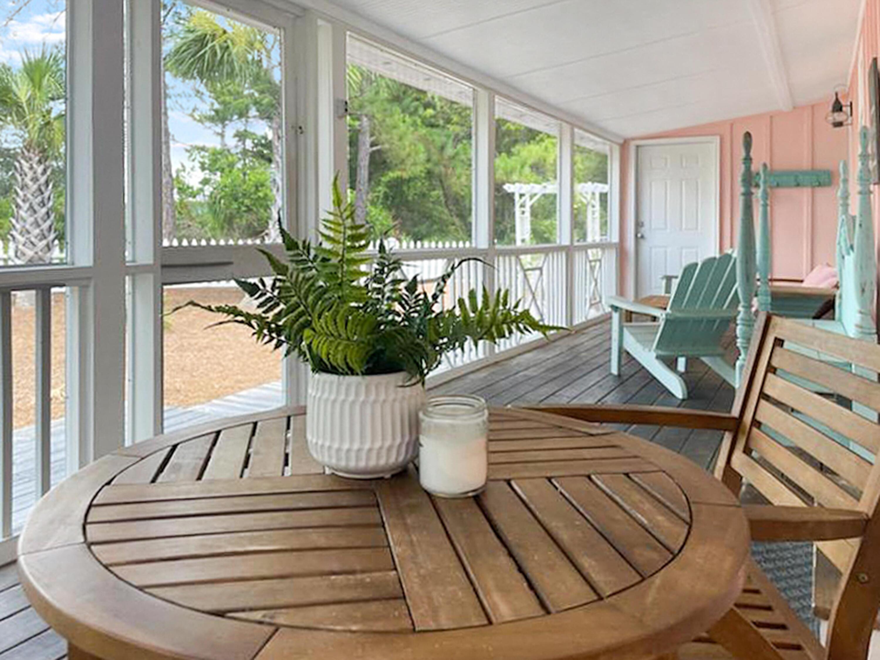 Located in the heart of Seagrove beach just steps to the sugar white sand you will find old Florida charm in this tastefully updated beach cottage situated on a large nearly ¼ acre corner lot.  Hidden potential abounds, limited only by your creativity and desires. Like a precious jewel box, once opened you quickly discover amazing things come in small packages.  The setting is peaceful serenity.  The porch invites quiet time for coffee and a relaxing wine down to your beach day.   The floor plan is that of an open concept joining living, dining and kitchen in one unity.  Interiors are light and bright with fine finishes such as white quartz countertops, pine hardwood flooring and v groove shiplap ceilings.  Seaside is an easy approximate 1.5 bike ride making this an amazing opportunity to capitalize on short term rentals, if desired.  Exterior features include an outside shower, a detached golf cart garage and fantastic parking.  Do you add a pool, expand on the footprint?  Do you live here full time, retain as a second home or use an investment rental?  All amazing options, you decide.