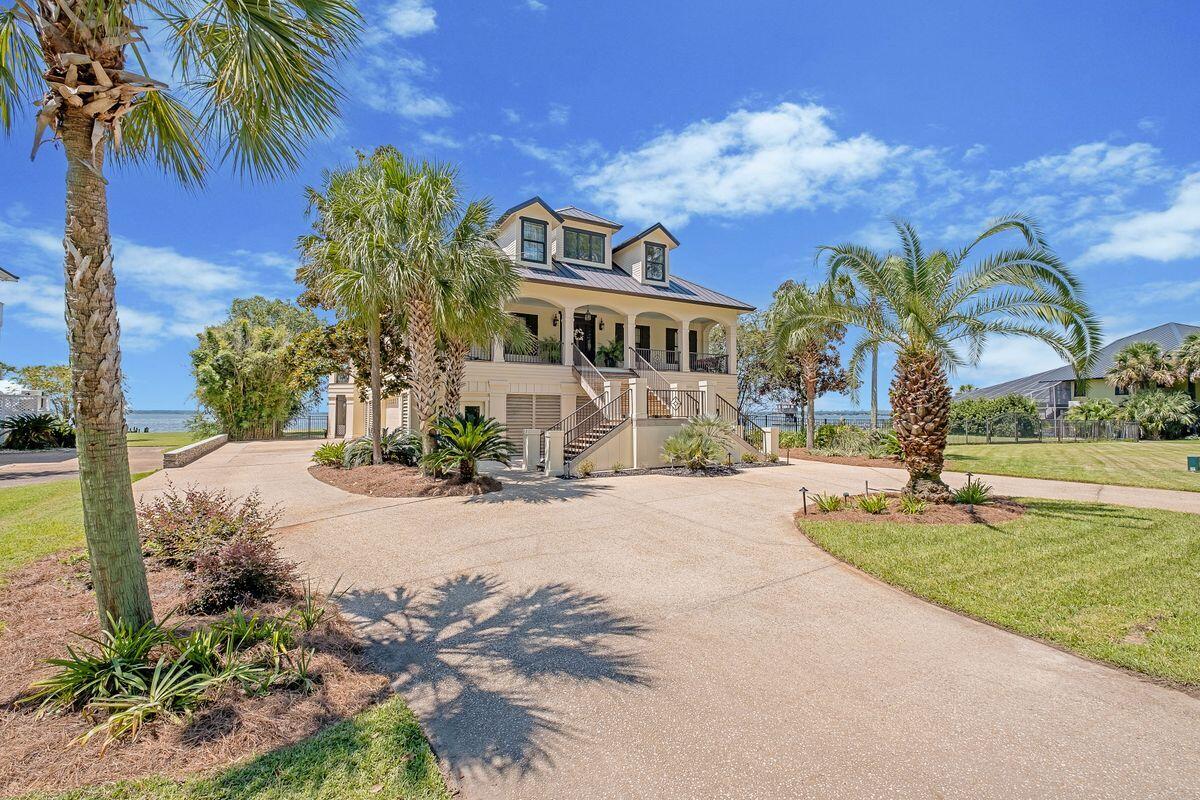 Salt + Serenity Home offers an unrivaled waterfront lifestyle on Escambia Bay with sweeping 270° views. Located in the exclusive Bayside North Island community, this elegant estate features an elevated, landscaped lot, circular drive, and grand entrance with classical arches. Inside, find soaring hand-painted ceilings, pine floors, and a spiral staircase leading to a bonus bistro area. The chef's kitchen includes a granite island, gas range, and custom cabinetry. Living areas showcase bay views, a fireplace, and formal dining. The primary suite is a retreat with spa bath and French doors to the water. Outdoor perks include covered decks, a screened lanai, and deep-water access—ideal for boating and entertaining.  This isn't just a home—it's a legacy, a retreat, schedule your tour today.