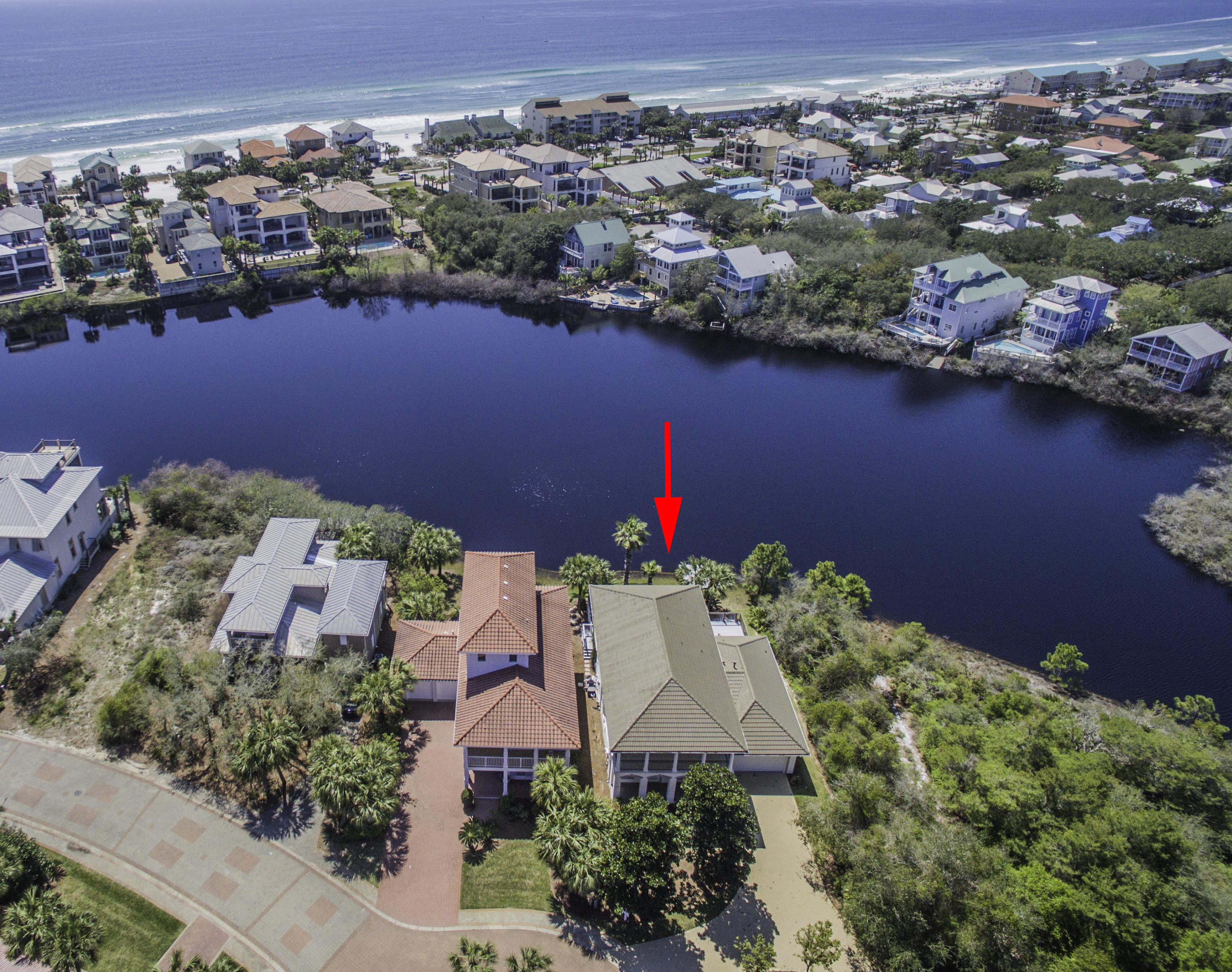 Breathtaking lakefront private oasis at the end of Sunset Pointe within the coveted beach community, Destiny West! This is a newly renovated 4-bedroom, 4-bath home complete with luxurious finishes throughout. The entire home is light and bright with ample windows bringing beautiful natural light and lake views in while the coastal palate and decor enhances the sense of ease. As you walk through the door you are greeted by a stunning spiral staircase and cathedral ceilings. The interior has been fully renovated with tile floors in the main living areas and upscale carpet in the bedroom. The craftsmanship and attention to detail is apparent with the thick custom crown molding, built-in shelving, and natural stone garden. The living area features a gas fireplace to enhance the ambiance. Off the living area there is direct access to a phenomenal covered patio and open pool deck with a lake front lagoon pool, hot tub and gas grill to enjoy. Steps in place down the the lake with a designated dock for sunning or fishing. 
  
The state of the art dream kitchen features custom painted hardwood cabinets, beautiful countertops and stainless steel appliances. The ground floor also features a formal dining area, spacious guest bedroom and bath for convenience, a built-in granite wet bar, laundry room with a full size front load washer & dryer, sink and storage, and two-car garage.

The upper level offers an incredible master suite with trayed ceiling and private balcony lending views of the lake and pool. The en-suite master bathroom is absolutely phenomenal with a custom shower with natural pebble flooring, glass subway tiles and custom backsplash. There is a freestanding soaking tub, granite double vanity area and a large walk-in closet. 

There are two guest bedrooms with a shared guest bathroom and additional balcony. The home is being sold unfurnished but does include all appliances. This would be a perfect full time residence or rental investment. The property is currently rented through Five Star Beach Properties and has established rental income. One of the most unique features of this property is the serene and private location and that each bedroom has direct access to an outdoor space. Not to mention the overall aesthetic is sure to impress! 

Destiny West is a private gated Gulfside community with luxurious amenities including a Clubhouse with full kitchen, lagoon pool & hot tub, fitness center, tennis courts, and beach access. This home offers a 2-car garage, paver entry & covered patio, beautiful landscaping with fenced yard, and is close to the beach and pool area. Do not miss out on this incredible opportunity to own a beautifully renovated lakefront home close to the beach.