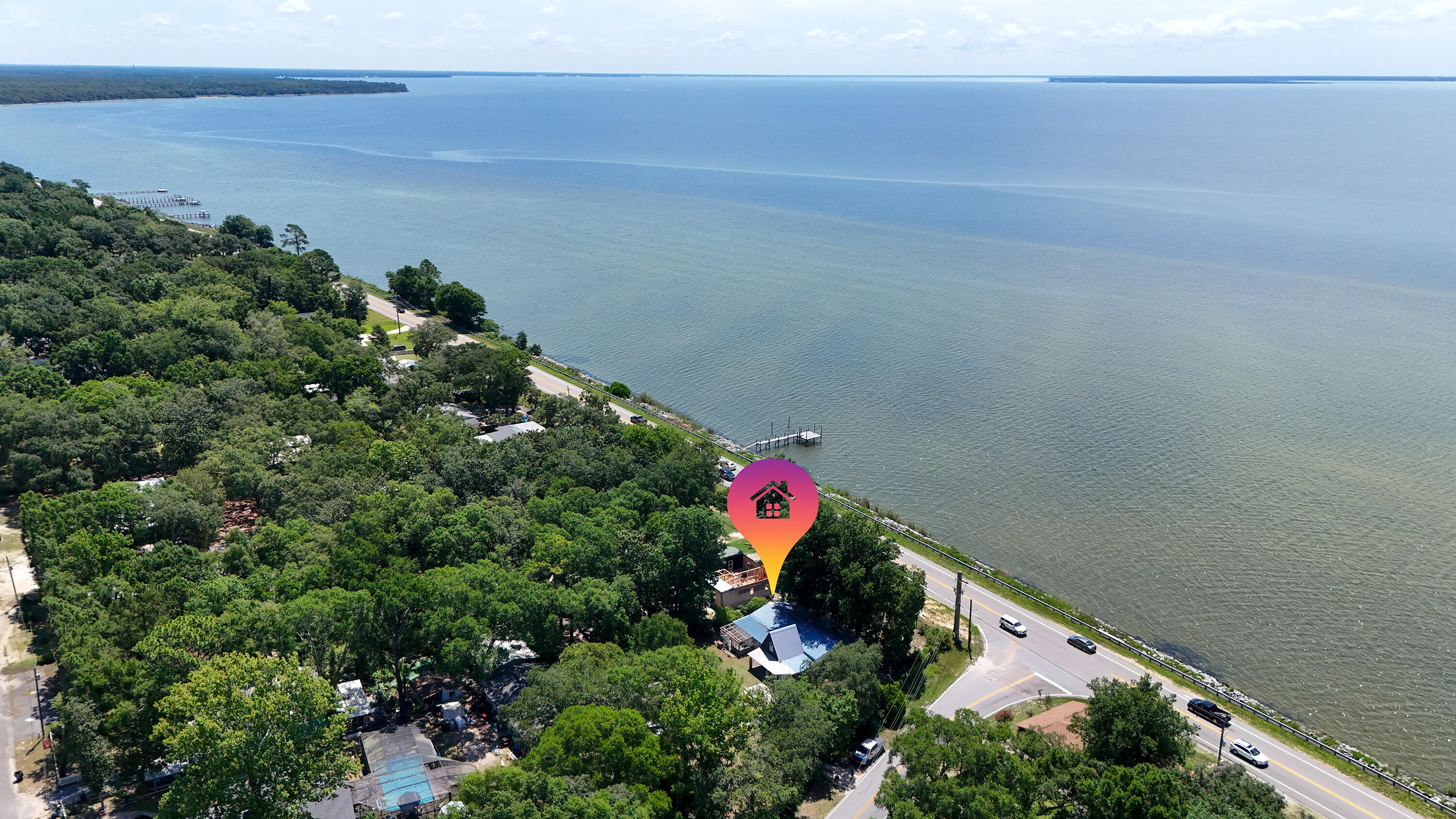 Incredible opportunity across from the Choctawhatchee Bay! This unique property spans two spacious lots, offering endless possibilities—whether you're looking to renovate the existing home or start fresh with new construction. The current 3-bedroom, 2-bath home offers great potential as a fixer-upper investment or a rental, with bay views just steps away.

With two separate lots, you have the option to demolish and build two new homes, making this an ideal project for developers or investors. Enjoy serene water views and bay breezes from this prime location, just minutes from Choctaw Beach Park, boat launch, and all that Niceville has to offer.

Don't miss your chance to own a piece of property in one of the area's most desirable water-view corridors—live in one, sell or rent the other, or create two dream homes. Opportunities like this don't come often! 

This property isn't just real estate; it's a canvas for vision. Whether you're a developer aiming for dual-new-build returns, an investor seeking value-add renovation gains, or a waterfront enthusiast dreaming of a beautiful Bayview residence, 13636 E State Hwy 20 delivers unmatched flexibility in a serene, high-demand location. Call today and make it yours!
