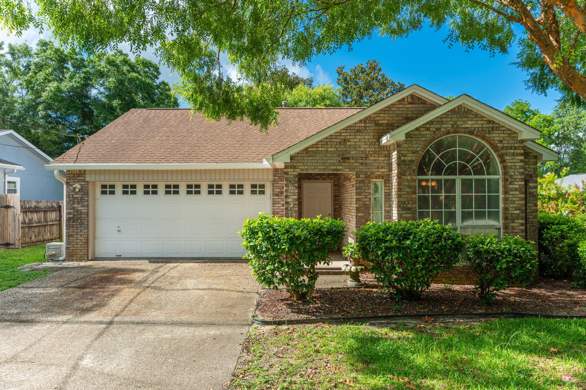 This one owner home has been lovingly maintained and is ready for new owners to add their own decorating preferences. The eat-in kitchen has a newer stainless refrigerator and gas stove. A gas fireplace is the focal point of the cozy living room which also has a sliding door leading to the deck. Master bedroom has an ensuite master bath and a large walk-in closet. Two additional bedrooms share a bath and both have large closets. Washer and dryer are included in the purchase. Enjoy the large partially fenced yard with mature landscaping and a great location between Bluewater Bay and Niceville with no HOA! Gutters with leaf filters installed in 2024, hot water heater 2018, HVAC 2008, termite bond with Florida Pest Control. A new roof is being installed in August 2024. Come see it today!