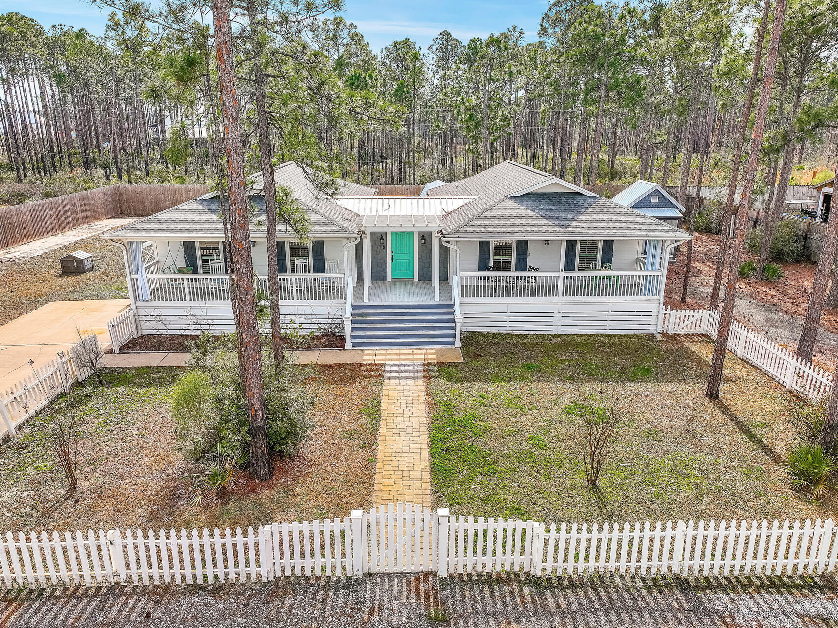 *Under contract with 72 hour kick-out clause in place.  Backup offers are welcome.*  NO HOA, parking for at least 6, RV parking! Welcome to your dream coastal retreat! This exquisite house is located SOUTH OF HIGHWAY 98 just 1.5 miles from the pristine beaches of 30A.  Golf cart ride to the beach!  Situated on a generous half-acre lot, this is a rare find at this price point and proximity to the beach. As you step inside, you'll be greeted by shiplap walls in the foyer and luxury vinyl plank flooring that continues throughout the home. The living room is adorned with an electric fireplace, creating a cozy ambiance for those cool coastal evenings.  The kitchen is a chef's delight, showcasing quartz countertops, soft-close cabinets, and a suite of matching stainless steel appliances that are both stylish and functional.
This property is being sold fully furnished, making it turnkey for your convenience. Whether you're looking for a primary residence, a vacation home, or an investment property, this house is ready to meet your needs.
Enjoy outdoor living at its finest with a large covered front porch and an open back patio, perfect for entertaining guests or simply soaking in the coastal breeze. The property also includes two spacious storage sheds, providing ample space for all your beach gear and outdoor equipment. For those with adventurous spirits, the RV hook-ups with a separate driveway offer a convenient and dedicated space for your recreational vehicle. No need to worry about finding accommodations for your RV - it's all taken care of here. The roof was replaced in 2022, setting you up with added peace of mind for the years to come.