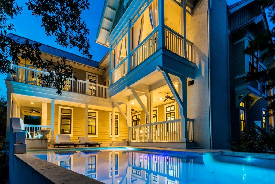 Call today to schedule your private showing for this outstanding lakefront home located in the coastal town of WaterColor. This custom home has unique finishes and details that you will not find in other Watercolor homes including 8-12 reclaimed antique heart pine floors and over $70,000. worth of Audio Visual Equipment throughout all 3 levels of this home. Three sets of french doors off the main living area open onto the outdoor living area with sweeping views of Western Lake. The pool and fountain area are the perfect spot to relax and enjoy the privacy afforded by this location backing up to preservation land and Western Lake. No one can ever build behind you to block these amazing views!! The second story outdoor living area comes complete with a Wolf grill, custom built BBQ smoker for your professional BBQ grillers, mini fridge and flat screen TV in addition to the dining set.  Enjoy beautiful views of Western Lake while cooking and dining on your porch!  The home is outfitted with Wolf and Sub Zero appliances not only in the kitchen area but also in the media room and outside living area.  The theater room is like no other in WaterColor with white washed pecky cypress walls, custom finished ceilings, reclaimed heart beams and of course a projection screen TV for your viewing pleasure.  Add to that a wet bar area and you have the perfect entertainment room.  The main living area has vaulted ceilings featuring antique beams reclaimed from the Tobacco Road area.  The living area flows into the dining and kitchen areas which feature antiqued granite countertops and custom backsplashes.  The elevator connects the first and second floors and is finished with antiqued gray stained white oak walls.  The home features two master suites, both with attached porches.  There are two additional guest bedrooms both featuring ensuite bathrooms and an additional bedroom currently outfitted with bunk beds.  The fourth floor tower has amazing views of Western Lake and nearly all of Watercolor.  This home was built to work well for a primary residence with ample closet space throughout the home, large fully air conditioned closets on the third floor and a one car garage.  If you are looking for an investment property, this home although never rented would be an excellent luxury rental home with impressive rental projections.  With nearly 2,000 square feet of porch space and over 4,000 feet of living space this home is an ideal Watercolor beach home.