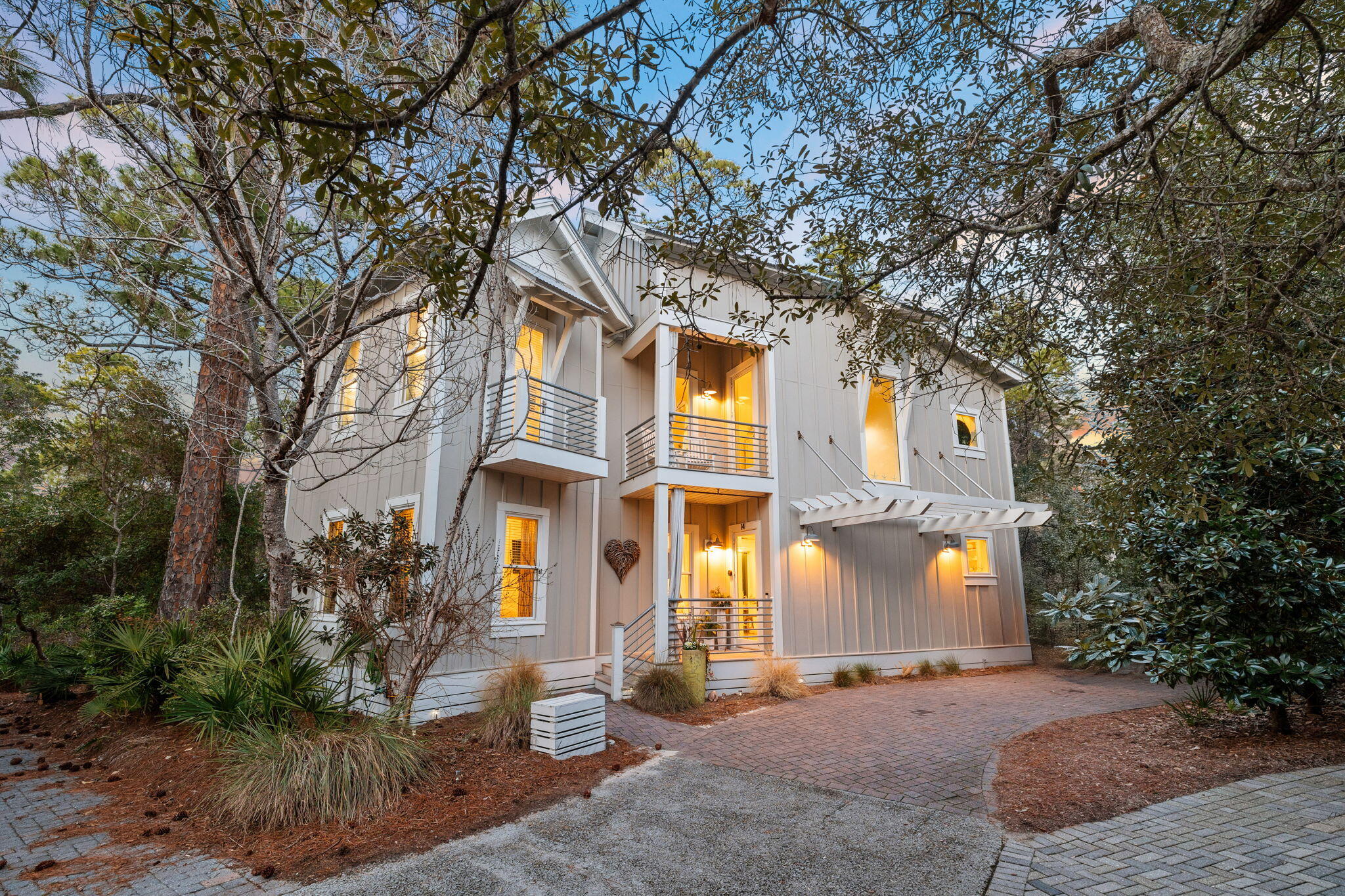 Located in the exclusive gated community of The Hammocks of Seagrove, this stunning 4-bedroom, 4.5-bathroom coastal retreat comfortably sleeps 12 and offers the perfect blend of privacy, charm, and convenience. Thoughtfully designed and professionally furnished, this turn-key oasis is ready to welcome you to the beauty of 30A living.  
Step inside to soaring ceilings and driftwood floors, complementing the coastal aesthetic. Each of the four bedrooms features its own bathroom, ensuring privacy and comfort for every guest. The primary suites - one on each floor boast walk-in closets, while a custom bunk room is designed with built-in bunks that comfortably sleep six, making it an ideal space for kids. Two separate living areas provide ample space for both relaxation and entertaining, while screened-in porches seamlessly connect indoor and outdoor living on both floors, offering serene views of the nature preserve. The kitchen boasts premium appliances, open shelving, and an inviting layout, flowing effortlessly onto a charming outdoor seating area.

The Hammocks of Seagrove community features two pools and is ideally situated just half a mile from the beach access. Enjoy a peaceful retreat while remaining moments away from the iconic shopping, dining, and entertainment of Seaside.