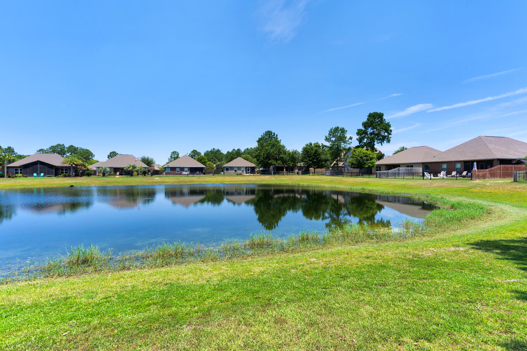 Experience coastal living in Hammock Bay, Freeport, FL, a master-planned community known for its eco-friendliness and top-ranked schools. This craftsman-style 3-bedroom, 2-bath home in the Passages subdivision offers LVP flooring, fresh paint, and a versatile room with French doors. Enjoy views of Passages Pond from the private master suite, complete with a garden tub, separate shower, and walk-in closet. Relax on the screened patio or by the gas fireplace in the cozy living room. Hammock Bay features bike trails, swimming pools, pickleball courts, and a variety of community events and amenities.