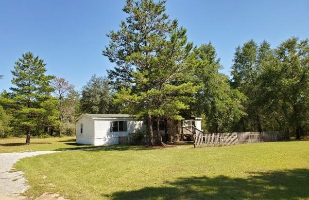 Real Estate Owned REO. Buy and hold for future investment in the fastest growing county in Florida. This 3 bed 2 bath over 1600 sq ft home is positioned in the center of this large almost full acre lot. The land is cleared around the home mostly with some trees left intact to give a natural privacy fence setting.Dishwasher, range hood, stove included.Very affordable price wit this lot sitting on paved road frontage. Large front covered porch to enjoy the late summer breeze. Large open back deck great for cookouts. You're sure to enjoy the peace and quiet this location has to offer. Located less than five miles from the Mossy Head school, the golf course on highway 90 and Mossy Head Park.This property may qualify for Seller Financing (Vendee) Call to take a look at 318 Lancelot Rd today.