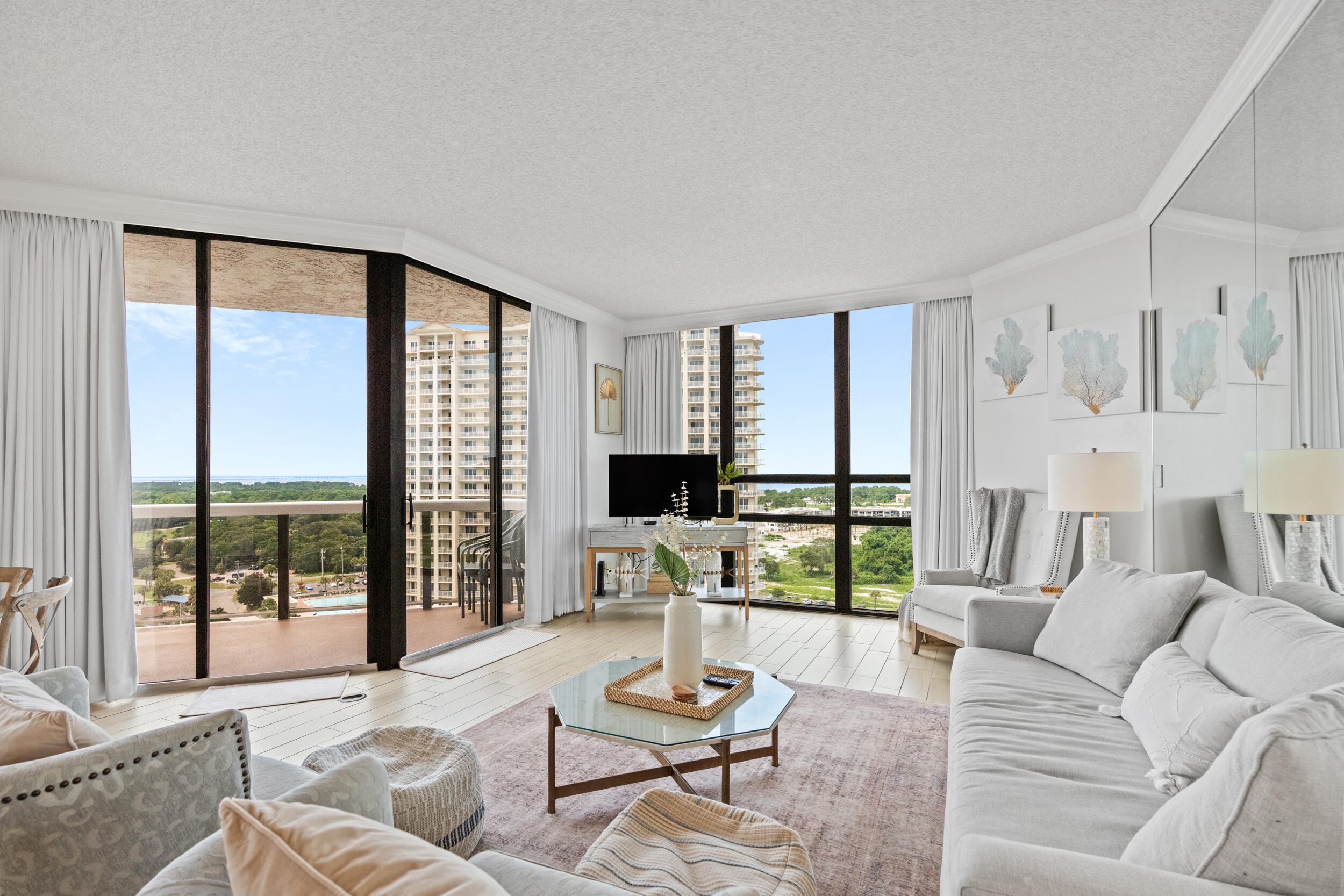 Breathtaking SUNSET views of the Bay and the Gulf of Mexico from this pristine 15th-floor residence in Surfside Beach Resort. This beautifully renovated 2-bedroom, 2-bath condo features a versatile lockout suite, with its own private 1-bedroom, 1-bath. The spacious interior is enhanced by soaring high ceilings, custom black-out drapes, and elegant upgraded tile flooring throughout, creating an open and airy ambiance. The condo comes fully furnished with new, stylish furniture, offering a turnkey living experience that blends comfort with sophistication. Surfside Resort offers unique owner amenities including: A newly renovated Owner's Lounge, Beach Service paid as part of HOA dues, 1512 has 2 parking spaces in the private Owner's garage, and an Awesome Beach Bar! It is a very popular family resort with its own private beach and there is always something for the whole family to do!  Enjoy the large pool deck, convenient private beach walkover, seasonally heated pool, two hot tubs, sauna, baby pool, basketball, tennis and pickleball courts, BBQ grills and on-site rental management. Surfside has covered parking, heated/cooled interior corridors, the Royal Palm Grille restaurant, poolside bar & day spa! What else could be on your wish list?