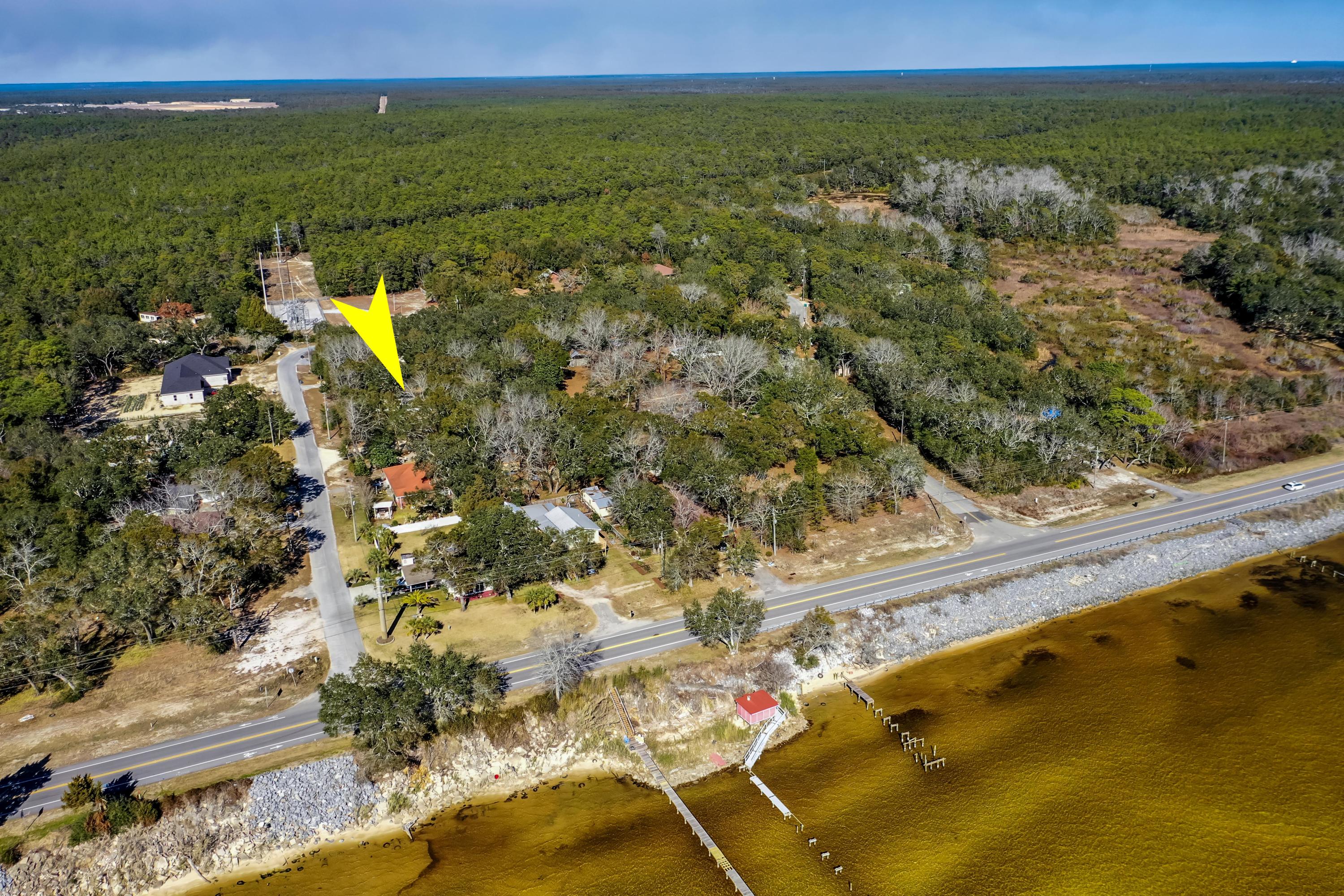 Ready to Sell - Price Reduced! Opportunity to own 3 adjacent lots totaling 1 acre within view of the Bay in Choctaw Beach. Property includes a 2013 modular home with 3 BR/2 BA and older detached single family home with 4 BR/2 BA and several out buildings. Lots of possibilities to live now, build later or re-create entirely. Flood zone X. Yard is mostly fenced. Surrounding parcels/acreage to west and north belong to Eglin Air force Base making a quiet and wooded location less than 10 minutes to Mid-Bay Bridge and all the resort amenities Destin has to offer.