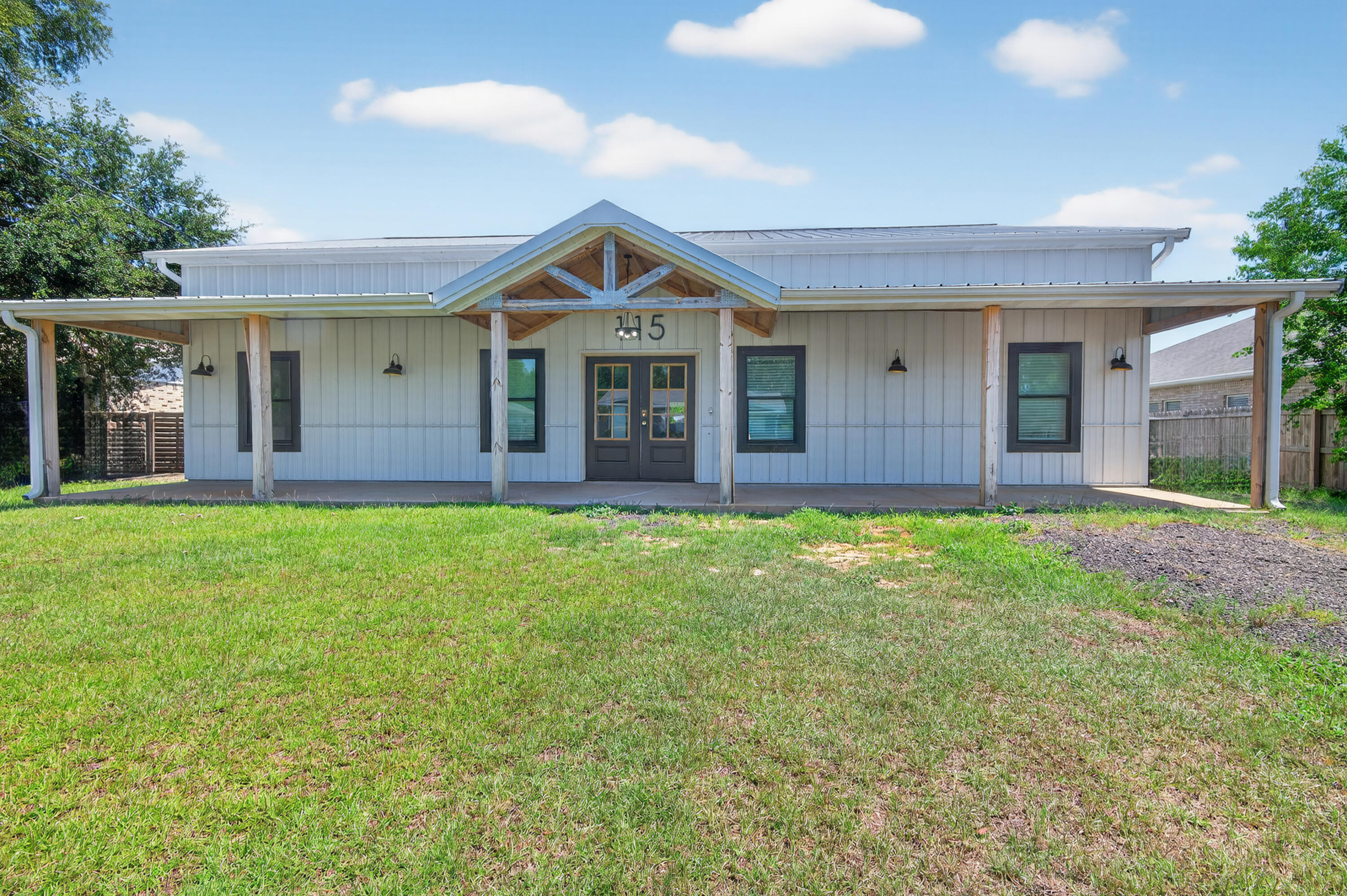 Built in 2023, this modern farmhouse offers a rare blend of style, space, and function just minutes from Hurlburt Field, local schools, shopping, and the white-sand beaches of the Emerald Coast. Designed with a ranch-style layout on the main level and a spacious loft upstairs, this 2-story home features 5 bedrooms, 3.5 bathrooms, and soaring 11-foot ceilings throughout the main floor.
Enjoy bamboo flooring throughout, a bright open living area, and a well-equipped kitchen with new stainless steel appliances. The nearly half-acre lot is fully fenced and includes in-ground pool, two detached outbuildings with electric—ideal for workshops, storage, or hobby space.To help visualize this home's floor plan and to highlight its potential, virtual furnishings may have been added to photos.