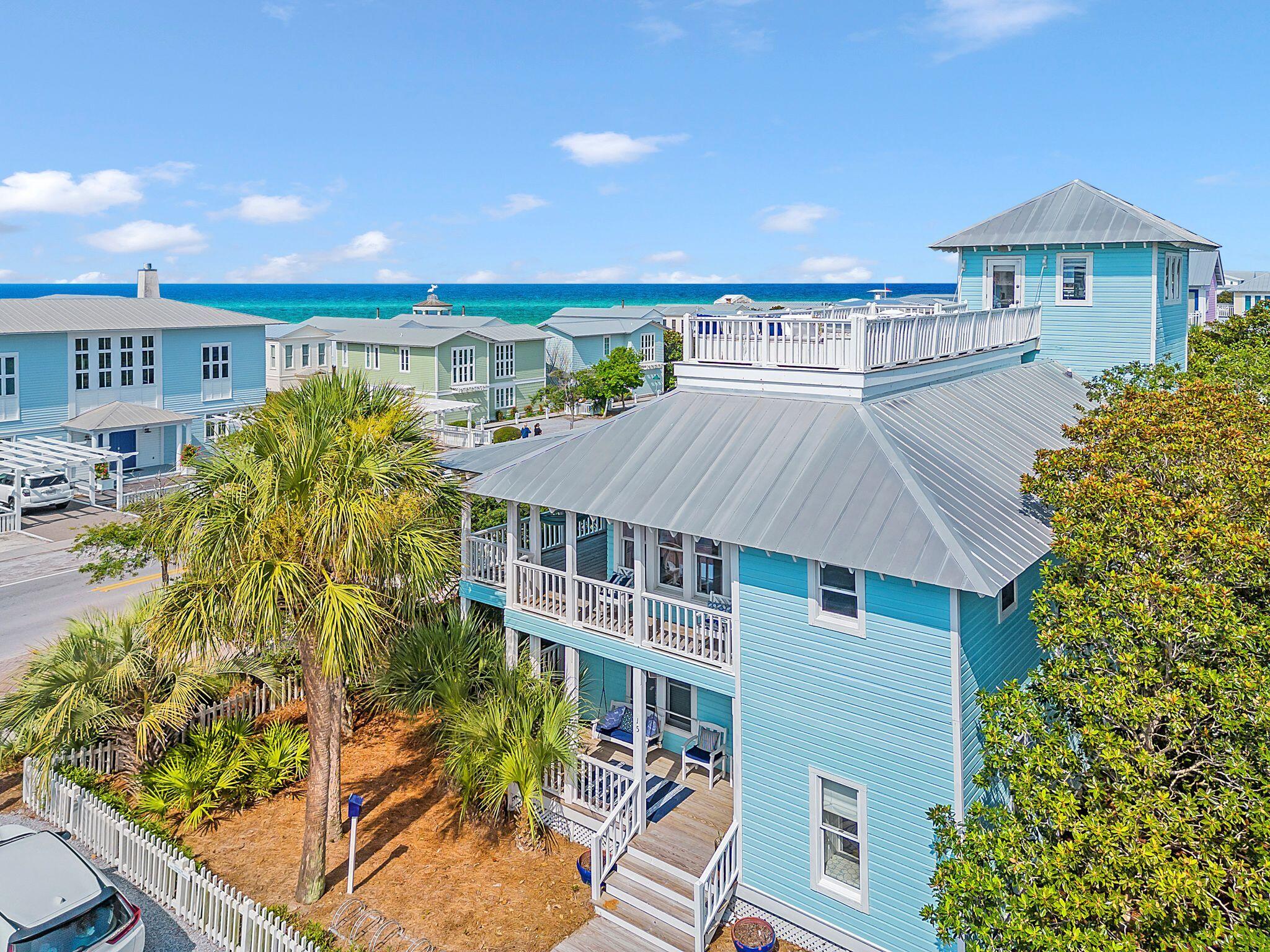 Coastal Charm awaits at this 4 bedroom 4 bath 2,774 SF Seaside beach cottage located directly on 30A and the corner of W Ruskin St. just one block from the Seaside town center and across the street from one of Seaside's nine private beach accesses. This home offers wood flooring and ceiling and white shiplap walls throughout and an abundance of porch space on each level allowing you to take advantage of Florida beach living.  This beach abode has a reverse floor plan with the main living area on the second floor allowing you to enjoy views of the gulf of Mexico better.  The first floor offers the master bedroom and master bath along with 2 additional bedrooms, each with their own ensuite.  The second floor boasts a soaring vaulted white shiplap ceiling accented with beautiful white wood beams and a large wrap around porch. The kitchen is complete with stainless steel GE appliances, beautiful marble countertops, a breakfast bar, a built in wine shelf over the refrigerator, and a large pantry.  The kitchen opens to the dining area which opens to the large living room that has built in shelving and cabinetry that accent both sides of the wood burning fireplace.  The second floor open floor plan is a great space to enjoy spending time and making memories with friends and family alike. The second floor has one bedroom with a built in bed and also a full bathroom. Journey on up to the 3rd floor which has panoramic views of the Gulf of Mexico!  Take a seat at one of the window ledge bar stools and enjoy a glass of wine from the wine refrigerator or wander on out to the rooftop terrace and smell the salt air and listen to all the sounds that the Gulf of Mexico and town of Seaside have to offer!  Seaside is an iconic beach town located on the scenic 30A corridor and was founded by Robert & Daryl Davis in 1981.  Seaside is situated on 80 acres but is a pedestrian scaled beach town designed so that all of your needs are within a short walk or bicycle ride away.  Seaside offers 3 community pools, a fitness center, tennis courts, pickle ball courts, croquet, shuffleboard, horseshoes, a post office, chapel, rep theatre, 9 private beach accesses, restaurants and retail stores.  

This home was built in 1990; the interior baths and kitchen etc have all been remodeled; a new roof was put on in 2013; new hvac systems were installed in 2020; the exterior siding does need some repair and the home is being offered AS-IS.
