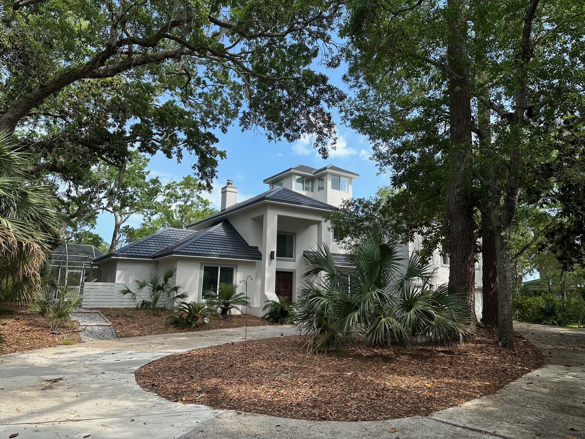 AMAZING PRIVACY & VALUE!! Priced below market for 167' water frontage & home's interior sq. footage! New metal roof 2025. Enjoy sun rises while dolphin, deer & osprey entertain daily. MAIN HOUSE contains 1st and 2nd floor master suites, large kitchen, and great room with soaring 20' ceiling.  Separate (above garage) apartment offers full bedroom, bath and kitchen/dining/living areas. Oversized 2-car garage. Buyer to confirm all dimensions.