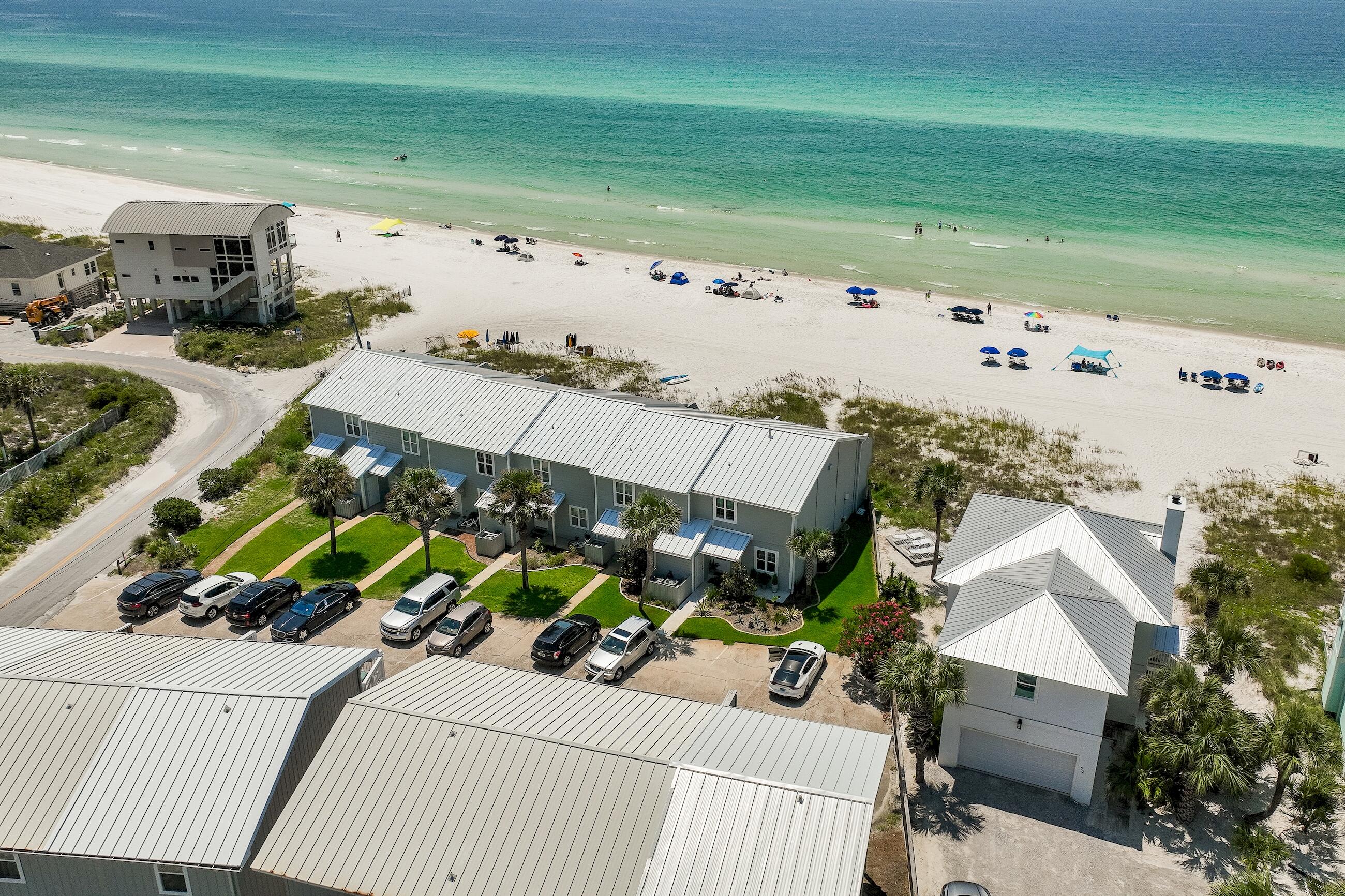 Life at the beach doesn't get much better than this! Shoreline Townhome Unit 12 is only 50 yards to the Gulf of Mexico and enjoys year-round beach access, allowing you the freedom to sit in the sand with your own chairs and tents daily. Renovated in 2021 with Gulf views from every level, this house is designed with an inviting mid-century modern feel showcasing an array of coastal colors to accent the sparkling waters of the Gulf of Mexico. The kitchen is outfitted with stainless appliances, and an oversized breakfast bar with quartz countertops which seamlessly joins the dining space for 6. Better yet why not spill out onto the covered patio and dine alfresco with your favorite bottle of Rosé, while watching the sun fade off the horizon? The private master bedroom on the third floor also provides panoramic Gulf views off the private deck. And the guest bedroom has been fashioned with custom wall bunks, in addition to a separate bed, which is perfect for the in-laws or grandparents. Shoreline Townhome #12 is being sold fully furnished and move-in ready, so there's nothing left for you to do but to grab your beach gear and start living the 30A coastal life.