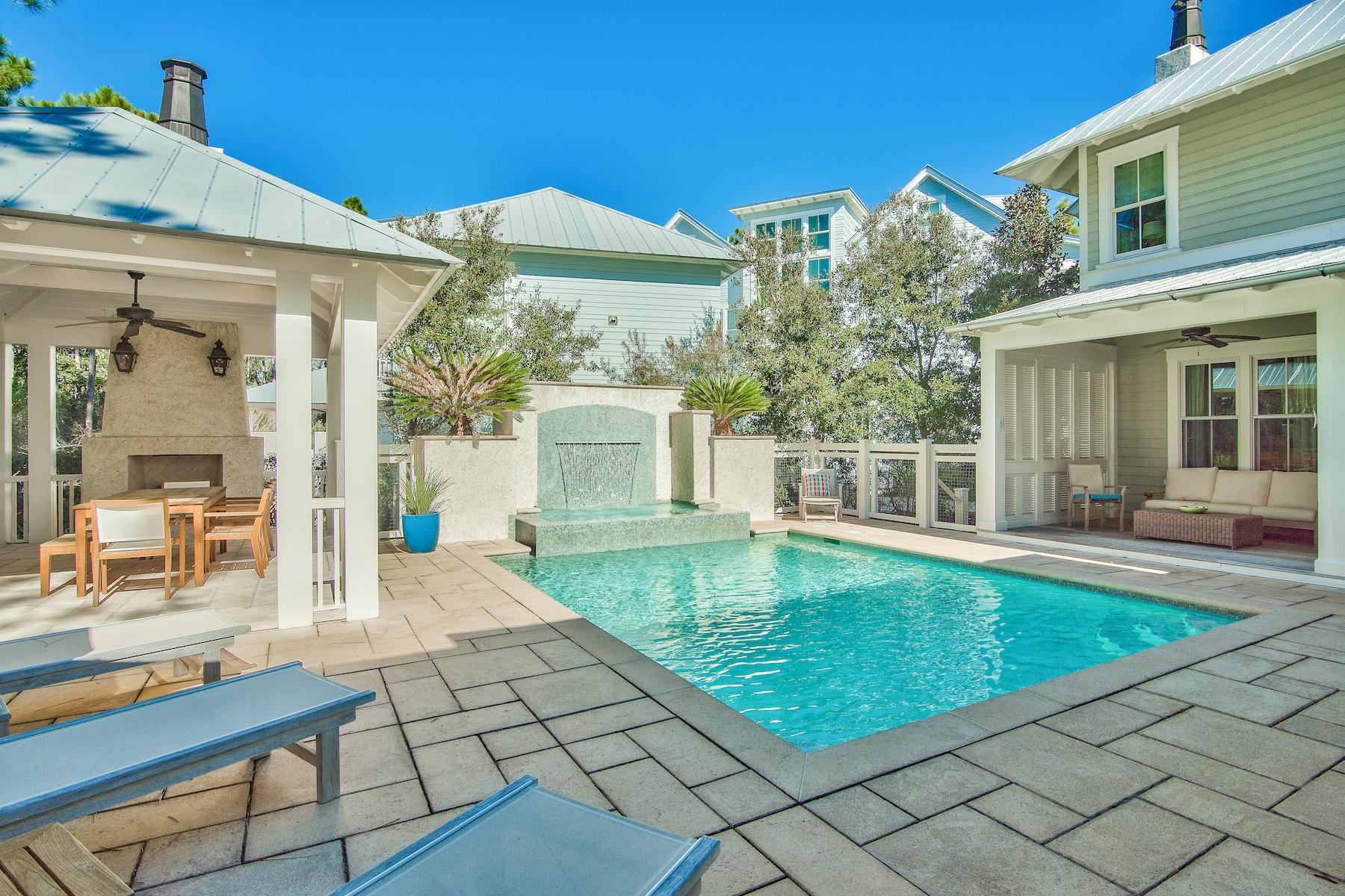 Offering what is, undoubtedly, one of the best outdoor spaces in Watercolor, this never rented custom home on a large corner lot in Phase II boasts nearly 4,000 square feet of wide open luxury living w/ 4 bedrooms, 4.5 baths and a detached 1/1 carriage house over the 2 car garage. Thoughtfully oriented to provide maximum privacy, bordered by lush forever green space, the resort-like backyard features a large private pool, covered summer kitchen with gas grill and fireplace, lanai w/ multiple seating areas, and an unobstructed sundeck. Back inside, this home is replete w/ high end finishes and natural light. The first floor features a luxe eat-in kitchen, separate dining room, coveted main level master suite, a warm and inviting great room, soaring white beamed ceilings, and shiplap walls. Upstairs, 3 en suite guest bedrooms complete the main house, each with ample storage, light and charm. With its own separate access, the detached carriage house with 2 car garage features a large bunk room with 4 bunks, a spacious living area, full kitchen, and 1 full bath. 

Watercolor is one of 30A's most desirable communities with its countless amenities and unparalleled location in the heart of it all.