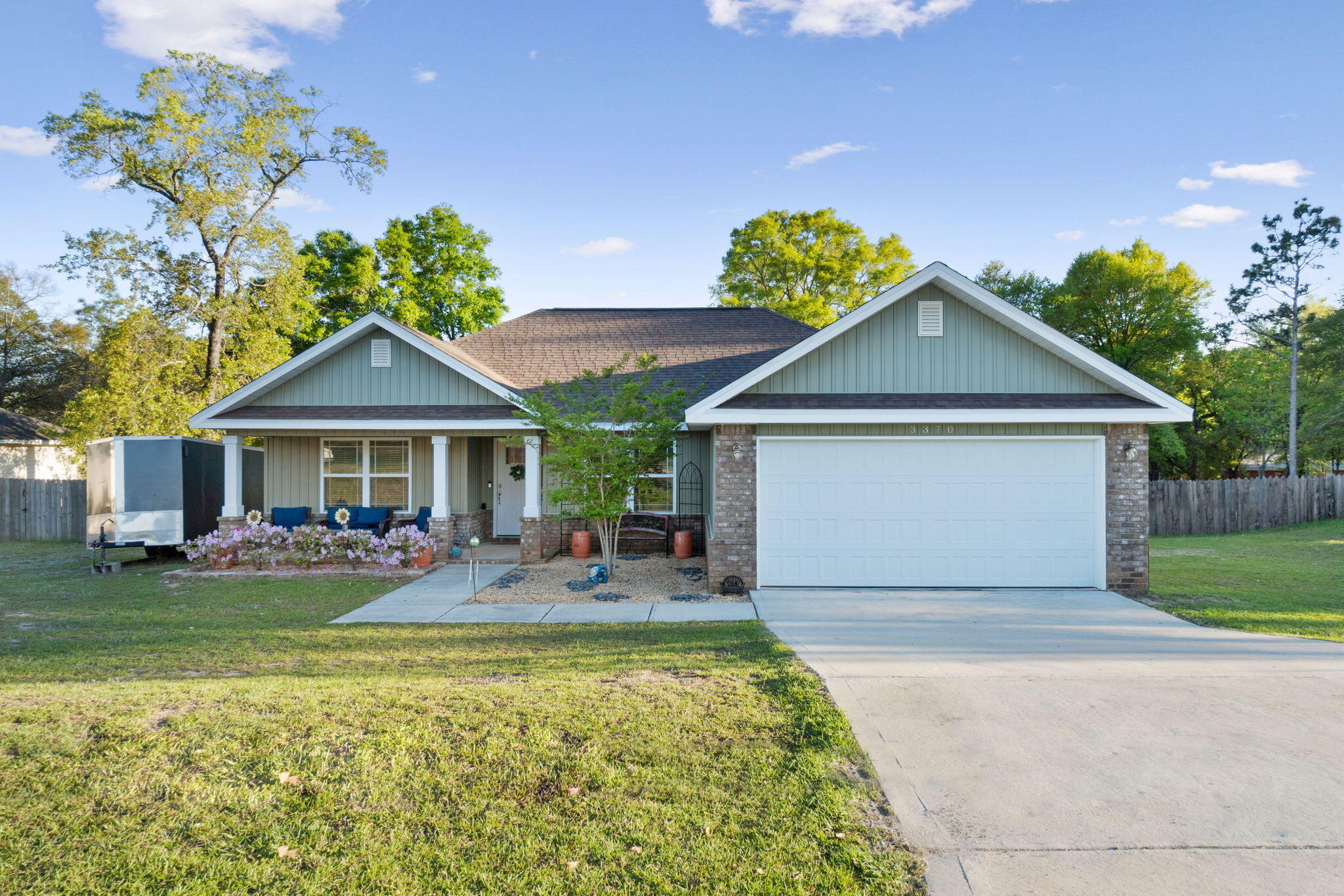 Welcome home to this lovely Crestview home! Built in 2021 by a quality local builder with the quality finishes you're looking for; you'll love this location nestled on a 0.35 acre lot with no HOA. Bring your trailer, boat, or RV, there's plenty of room to park it here! Pull into the driveway and appreciate the tasteful landscaping and covered front porch, and inside you'll love the open floor plan and soaring vaulted ceiling. Hard surface flooring extends throughout the common area accented by a custom lighting package. The kitchen is well appointed with granite counters, stainless appliances, and brushed nickel hardware. All the bedrooms have ceiling fans and ample closet space. You'll love the primary suite's trey ceiling and an en suite bathroom complete with double granite vanities, a separate shower, and soaking tub along with a huge 8.4"-4.9" walk in closet. The other two bedrooms on the other side of the house have the same hard surface flooring with a shared bathroom between them. There is also a spacious interior laundry room as well as a two car garage. Outside is a great sized backyard fully fenced in with a privacy fence and a super convenient 10x16 storage building. Enjoy lower taxes and insurance with this beautiful find!