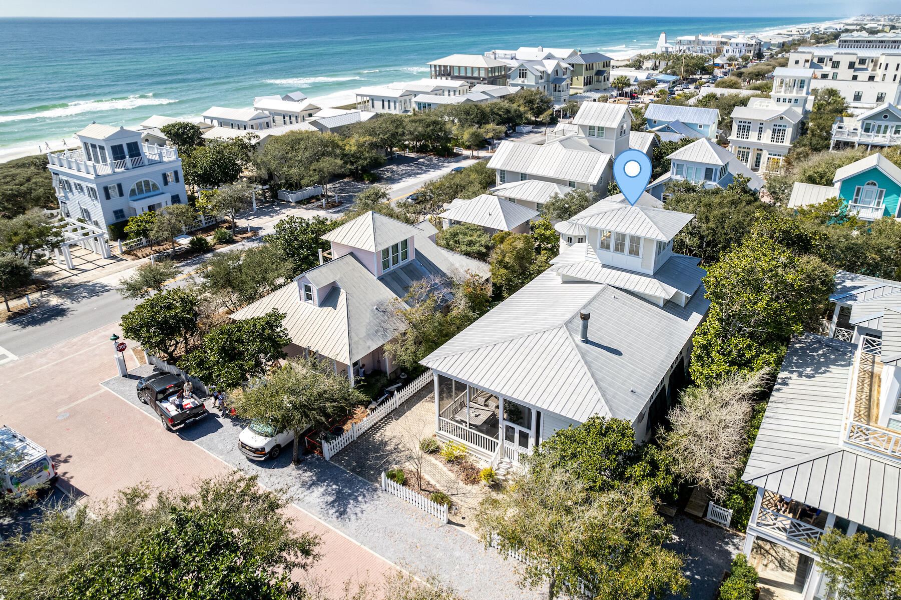 Sophisticated beach elegance at its finest. Located only two lots in from 30A, just a minute stroll to the beach. This updated southern charmer has been featured in House & Garden and Veranda magazine. Life revolves around the outdoor spaces of this beach cottage. The wrap-around screened porch is perfect for outdoor living. Step through the beautiful mahogany front door into the foyer with floor-to-ceiling bookcase. French doors with transom windows flood the living and dining areas with natural light. The home is designed for easy living; comfortable slip covered sofas and gas fireplace for chilly nights as the season starts to cool. A beautiful chandelier hangs from the 14' ceilings with crown molding. The 12' dining table seats 10 with slip covered chairs and bench seats. French doors off the kitchen open onto the screened porch. Amenities of the kitchen include a table and chairs for your morning coffee, pantry, Wolfe gas stove, Subzero refrigerator, Bosch dishwasher, granite countertop with a deep stainless-steel sink. Down the hallway are two guest bedrooms and two baths. The primary suite is located on the second level and features an office/sitting area with his and her closets. The primary bath has a double vanity, soaking tub, and separate shower. Head up to the enclosed tower for gulf and sunset views. Entertain your family and friends on the back porch with an outdoor fireplace and summer kitchen. The guest house interiors are a crisp white with a natural finished wood spiral stair. Paved onsite parking for two cars and a golf cart.