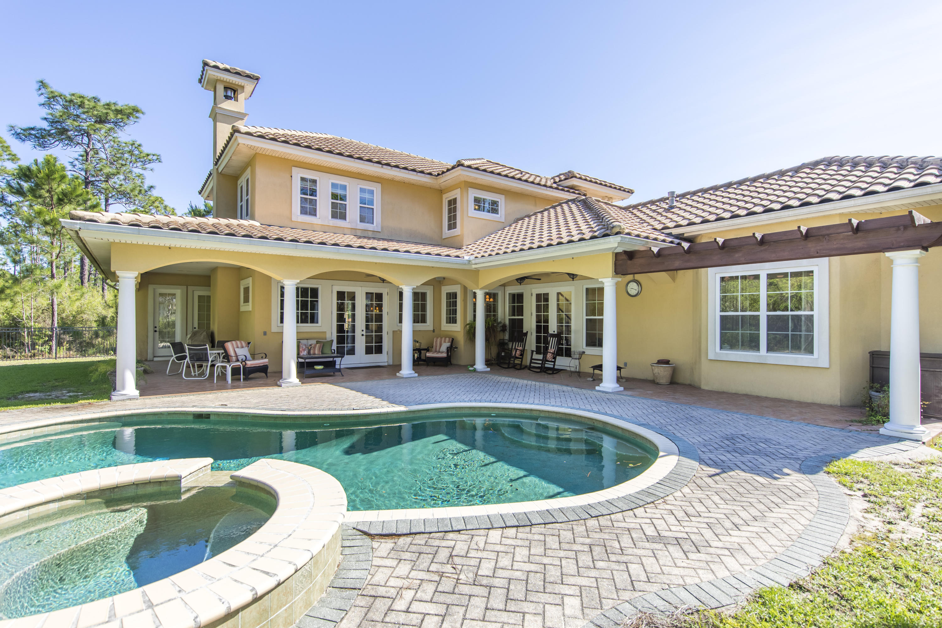 UNDER CONTRACT WITH CONTINGENCY - SELLER ACCEPTING BACK UP OFFERS.

Located in the heart of Trieste, this finely appointed, Mediterranean style residence offers a premium executive lifestyle with juxtaposition of beautiful landscaping highlighted by ample privacy yet perfectly positioned a short distance from shopping, restaurants, the Gulf of Mexico, and the renowned Holiday Golf Course. Boasting 3,637 square feet, and over a 1/3-acre premium lot in a private cul-de-sac, this four bedroom, four and a half bath custom-built home is characterized by esteemed architectural elements constructed by Rita Jones Homebuilders anchored by an exceptional open floorplan specifically designed for legacy living and optimizing entertaining space. Notable features include two master bedrooms, a spacious outdoor living area with luxurious gunite pool, split floor plan for ultimate privacy, first floor chef's kitchen complete with granite countertops, stainless steel appliances including a gas range and custom hood vent as well as ample cabinetry and an oversized central island with basin sink. The first level is anchored by a spacious open living room accentuated with custom crown molding and Brazilian cherry flooring as well as a gas fireplace all of which is open to the dining room, kitchen area and outdoor living space. Special attention to detail was taken with the addition of custom book shelves which flank the fireplace. The downstairs layout was designed to maximize functionality including providing an open concept for entertaining. 

Two bedrooms, and two full bathrooms occupy the upstairs as well as a 20x20 bonus room that can be utilized as an office, game room, or private getaway.

Modern luxury without sacrificing any of the Mediterranean charm of Trieste will make you fall in love with this executive residence.  Easy access to Holiday Golf, the Gulf of Mexico, and Pier Park as well as a low-cost HOA, make this home is an exceptional value. 

Trieste is an exclusive, Mediterranean style community with executive homes located on large, premium homesites.  Schedule your showing today, and find out why this home checks all of the boxes on your forever home wish list.